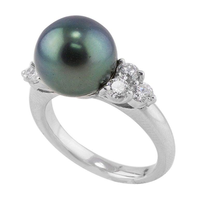 Tahitian Peacock Pearl Platinum Diamond Ring. This ring has a center cultured Tahitian pearl with a lustrous rich peacock color, the finest available with rich purple and green shimmering tones. The Tahitian pearl measures 11mm. The ring has six