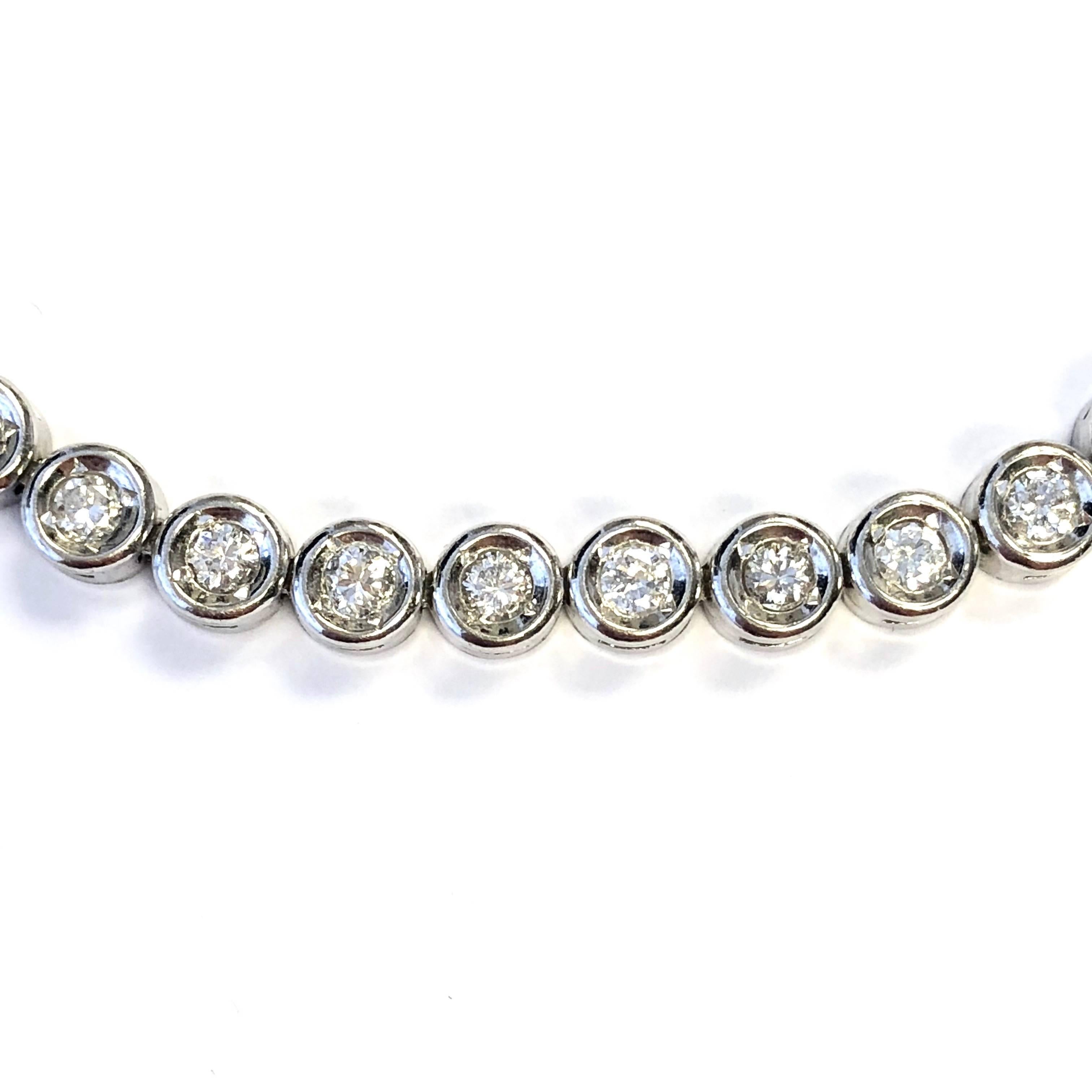 Platinum tennis bracelet, composed of 41 bezel set round brilliant cut diamonds. Total diamond weight: 2.01 ct (Stamped) Color: G-H, Clarity: VS2-SI2
Length: 7.5 inches
Weight: 18.9 grams