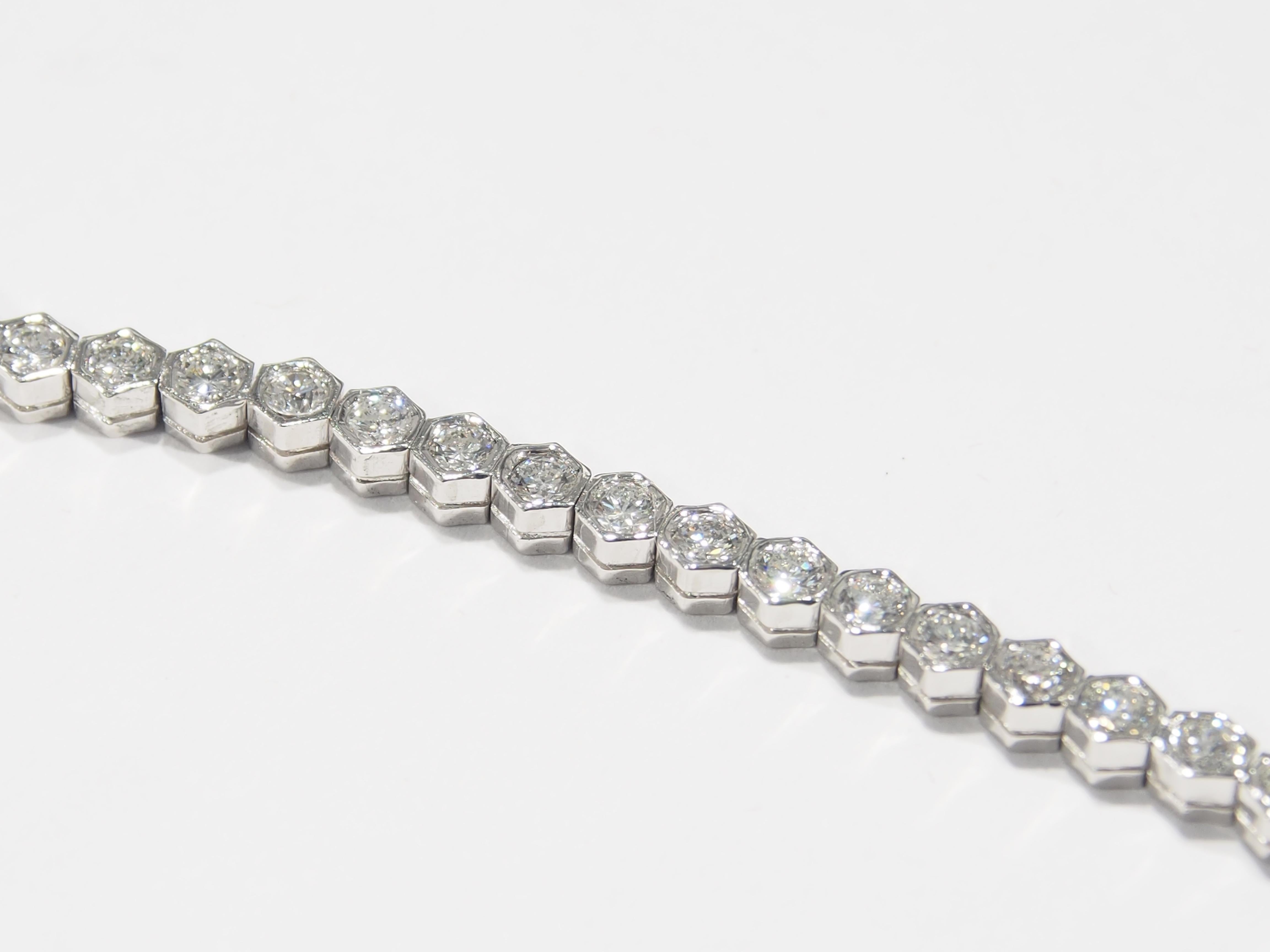 This is a classic Platinum Diamond Tennis Bracelet. There are (53) Round Brilliant Cut Diamonds, approximately 4.25ctw, G-H in Color, VS in Clarity sparkling in a bezel setting. A lustrous Bracelet to wear from daytime to evening weighing