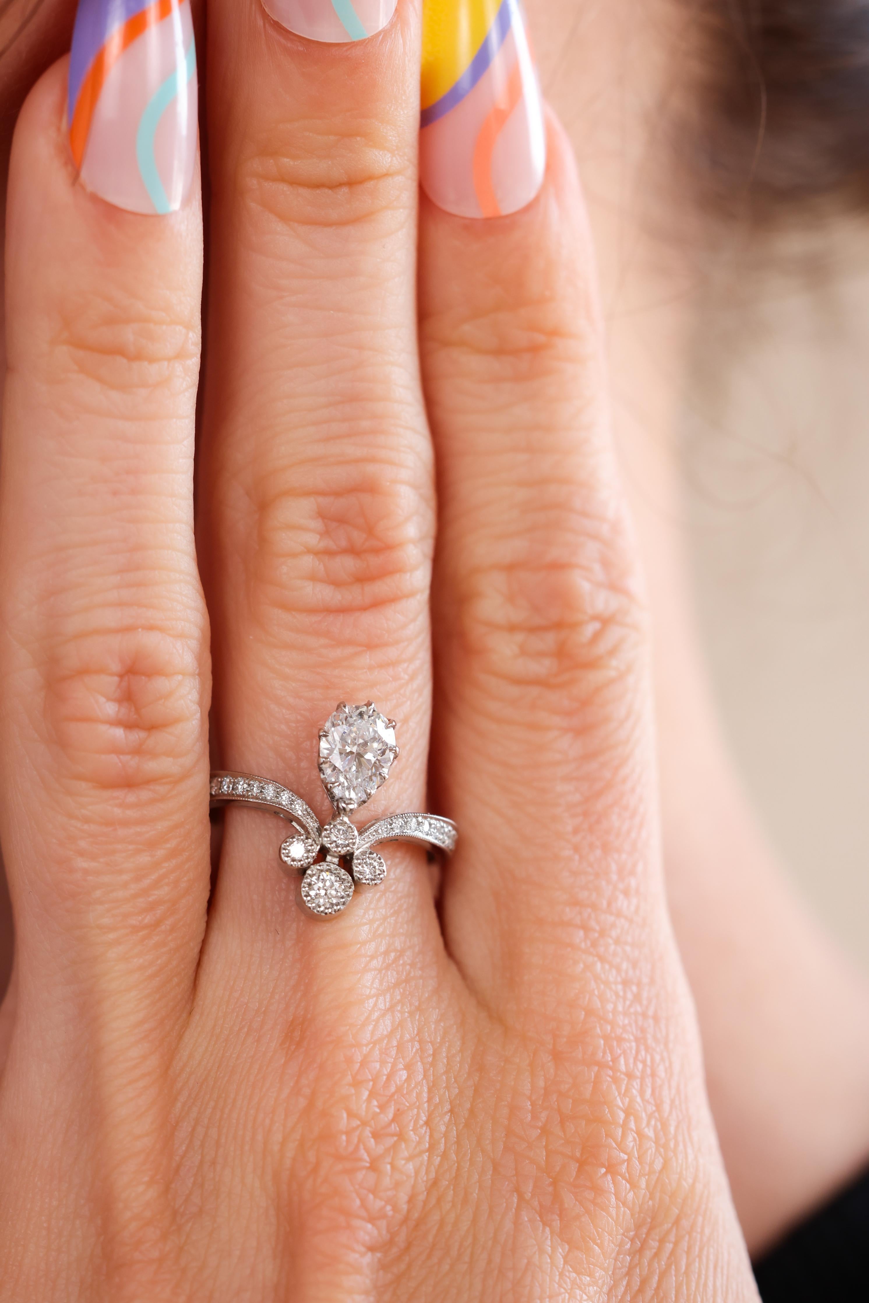 Trumpet & Horn's exclusive Tiara ring is reminiscent of Victorian times when jewelry and fashion were inspired by nature and romance. This unique diamond ring is made from platinum and features a GIA Certified Pear Shaped natural diamond weighing