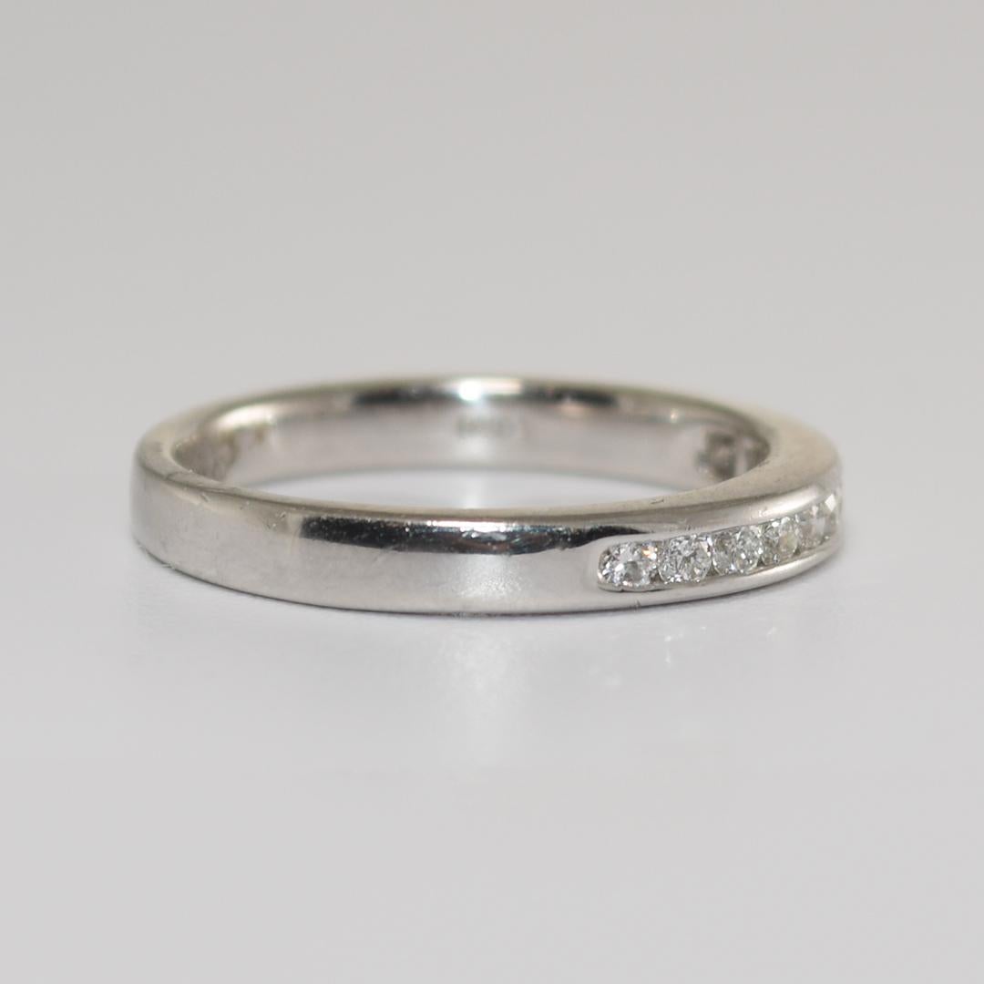 This band-style 950 platinum ring weighs 5 Grams.
It contains ten round brilliant diamonds, with a total carat weight of 0.30.
The diamonds have a VS to SI clarity and are mounted in a channel setting.
The ring measures 3mm in width and is a size