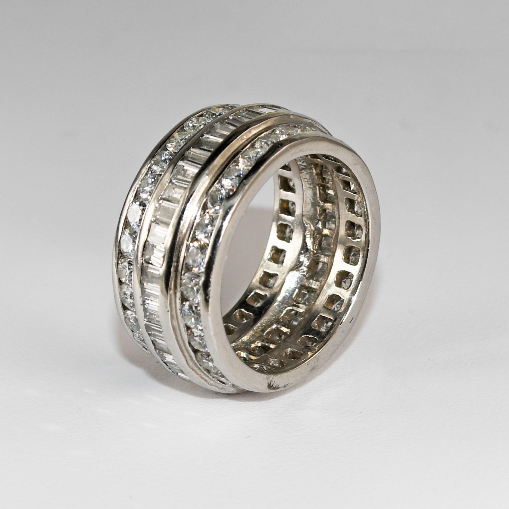 Custom-made platinum and diamond eternity band.
Stamped Plat. and weighs 13.2 grams.
All the diamonds go all around the circumference.
The center row of diamonds are baguette cuts, 1.00 total carats, H color, and SI clarity.
There are two baguettes