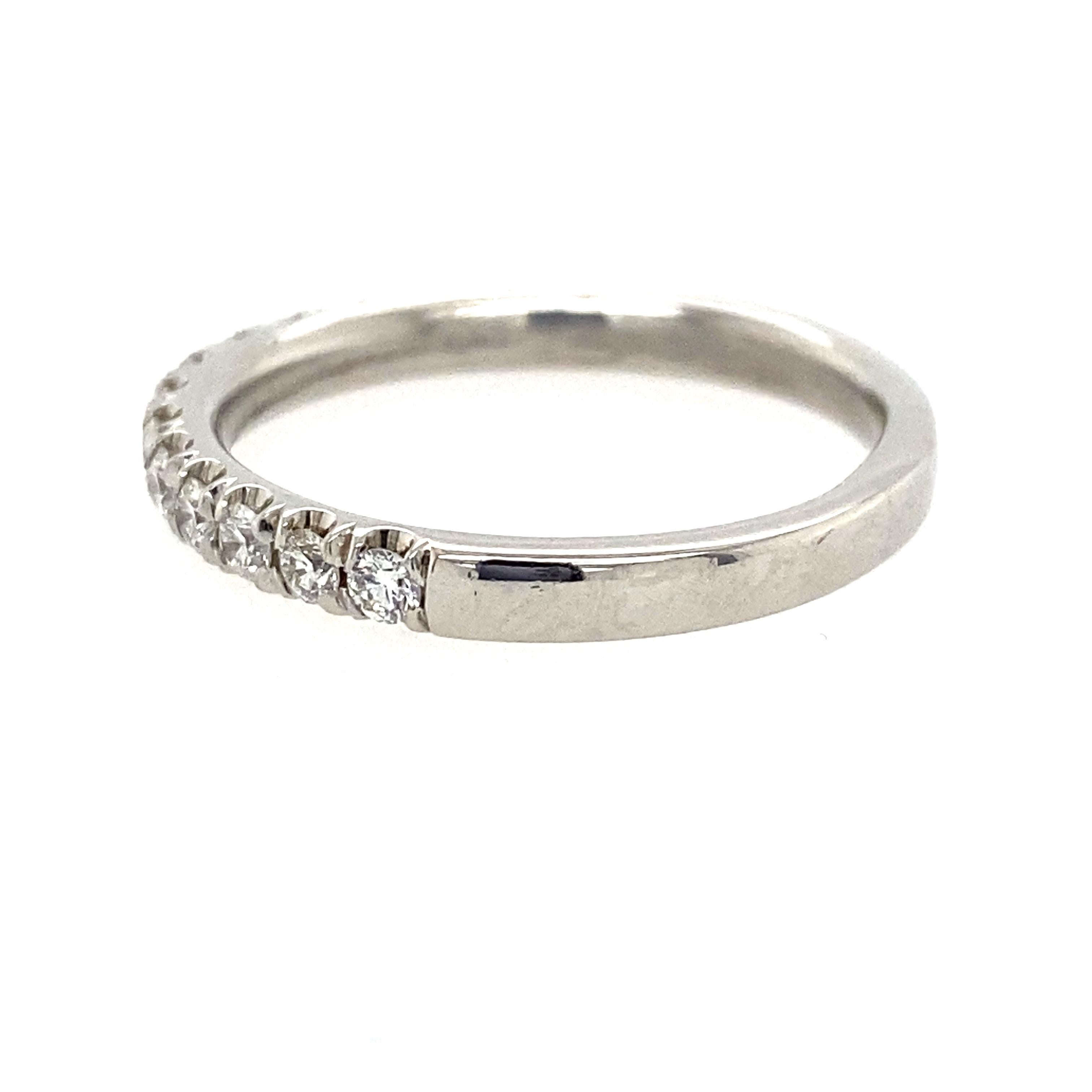 One platinum (stamped PT) diamond wedding band set with fifteen round brilliant cut diamonds, approximately 0.46 carat total weight with matching H color and VS2 clarity.