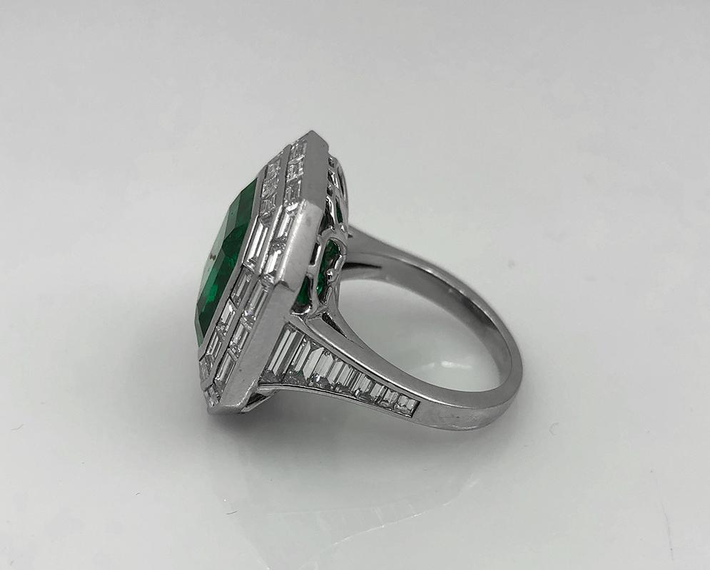Contemporary Platinum Emerald Diamond Ring 11.03 cts in Platinum.

An incredibly saturated square step-cut emerald surrounded by a double halo of baguette-cut diamonds gives this ring a Deco-style feel. Underneath the gem is brilliant openwork which