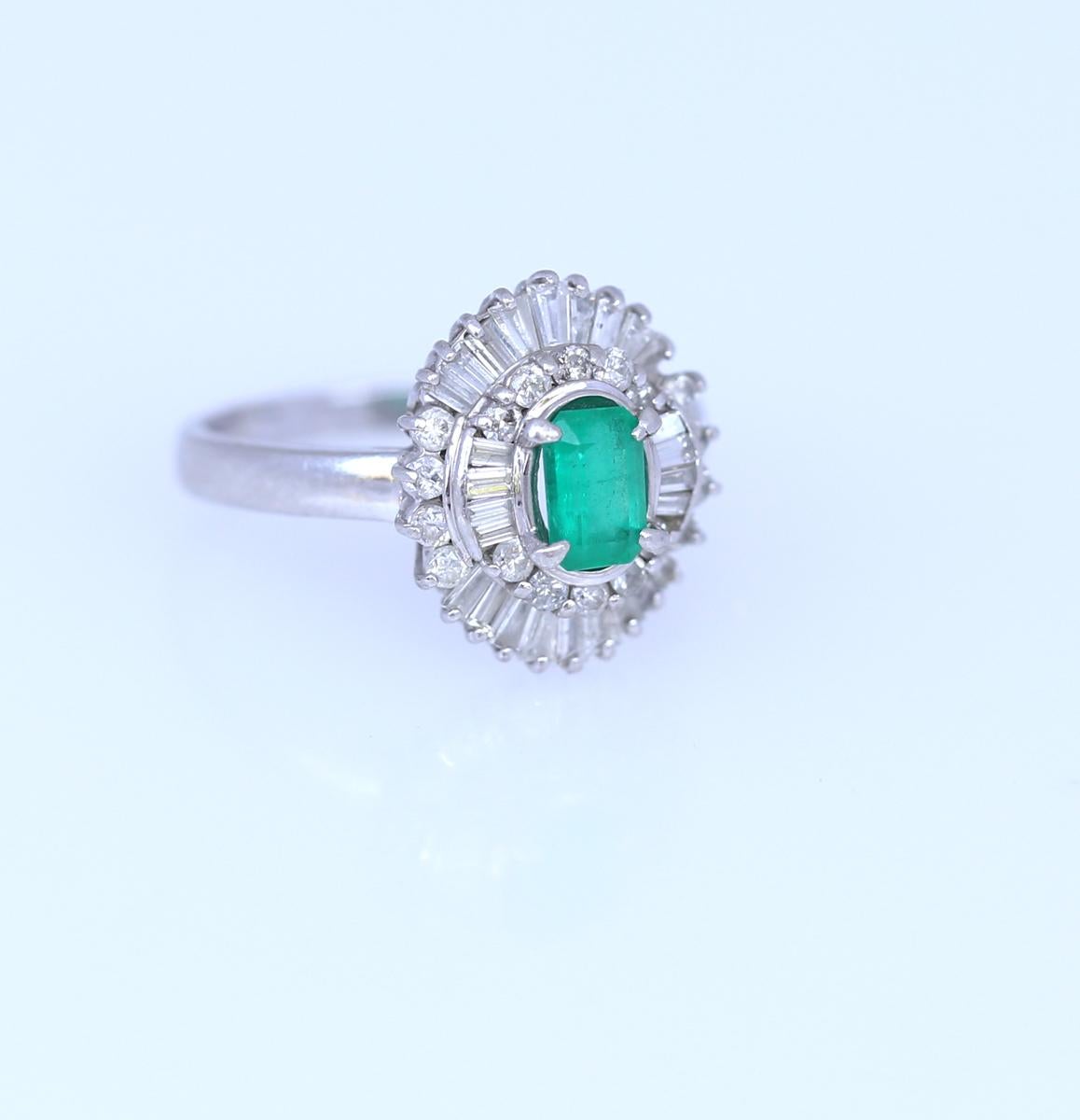 Fine Baguette and round cut Diamonds mounted in Platina surround an emerald-cut Emerald.  The whole fine design of the ring reminds of a magical flower. Total approximate weight of Diamonds: 1.7 Carats.
Delicate and elegant it is superbly crafted by