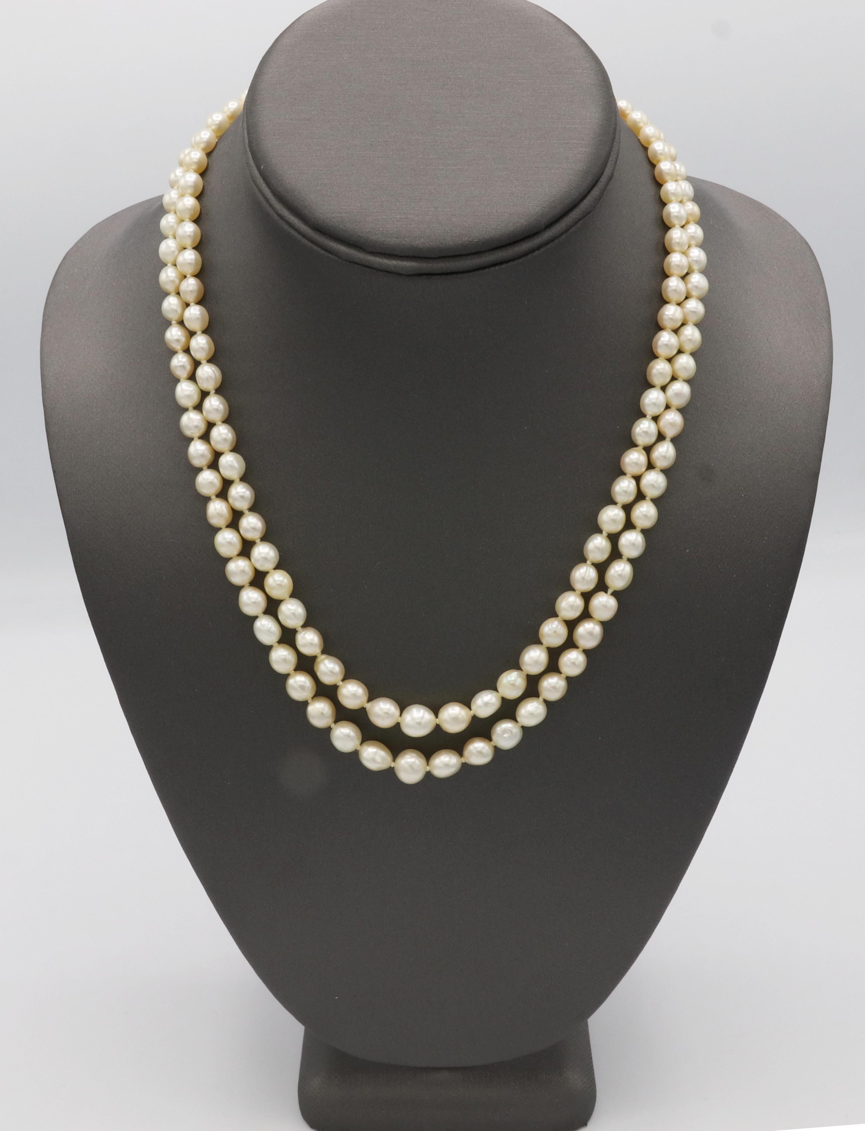Platinum Double Row Pearl Necklace with Natural Diamond and Sapphire Clasp  
Metal: Platinum
Weight: 50 grams
Pearls: 4.5 - 7.5mm white with creamy luster, oval, off round shape
Diamonds: 2 old European cut natural diamonds, approx. .50 CTW H-I