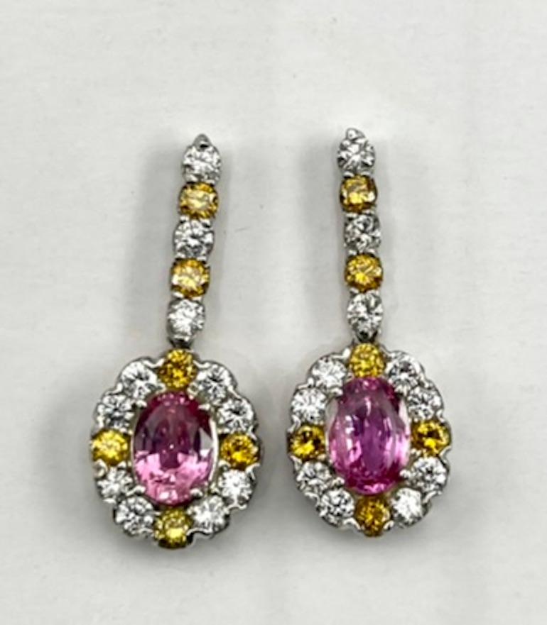 These earrings are a match to the ring listed. The Pink Orange of these sapphires looks like a Padparadscha color, which is among the rare colors for sapphires.  The color is clear, transparent and well spread. The Natural Yellow and White Diamonds