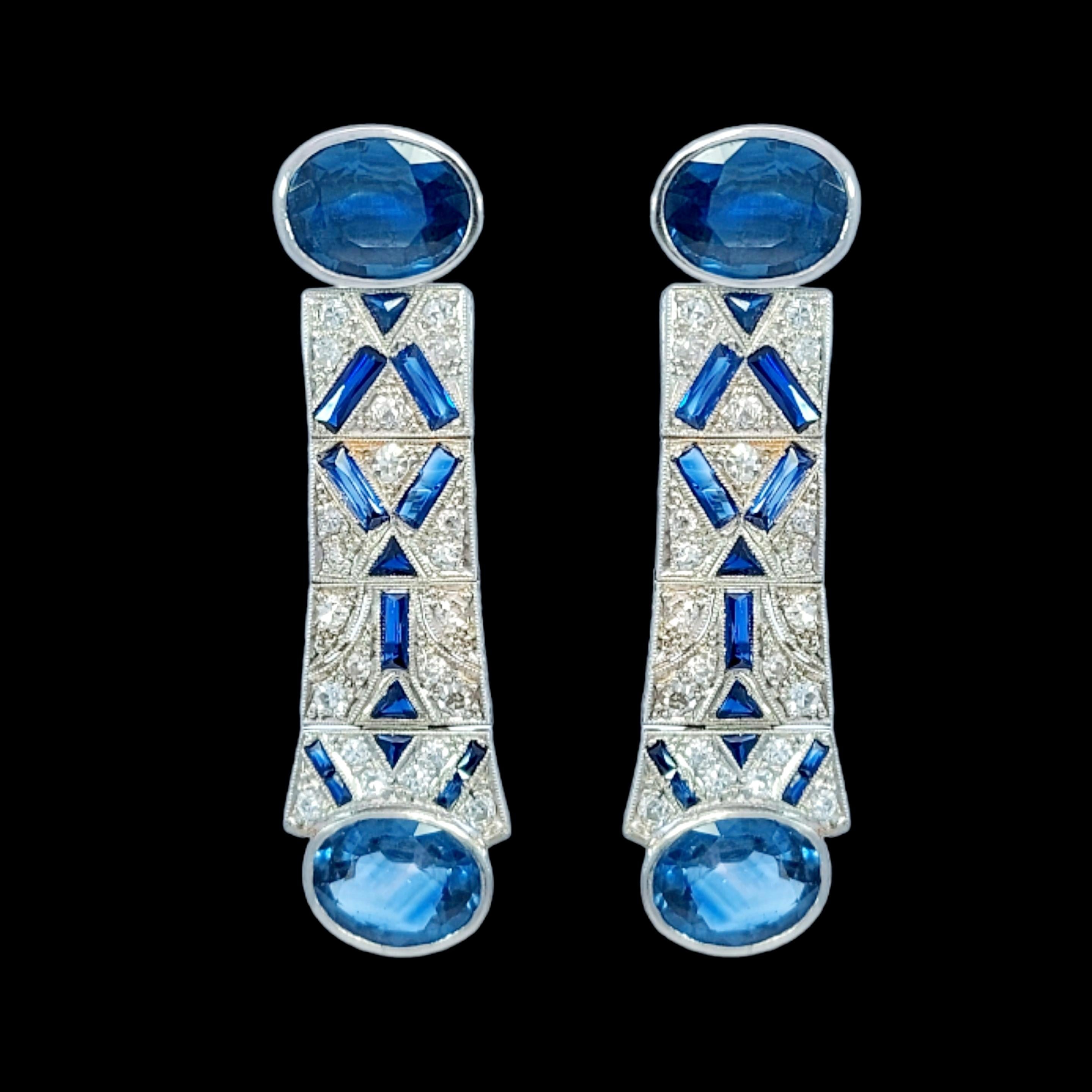 Platinum Earrings with Sapphires and Diamonds

Sapphire: 4 oval cut sapphires, baguette cut, triangle cut : 12 Carats

Diamonds: 22 brilliant cut diamonds together approx. 1.3 ct diamonds

Material: Platinum

Measurements: 45.6 mm x 12.8 mm x 3.6