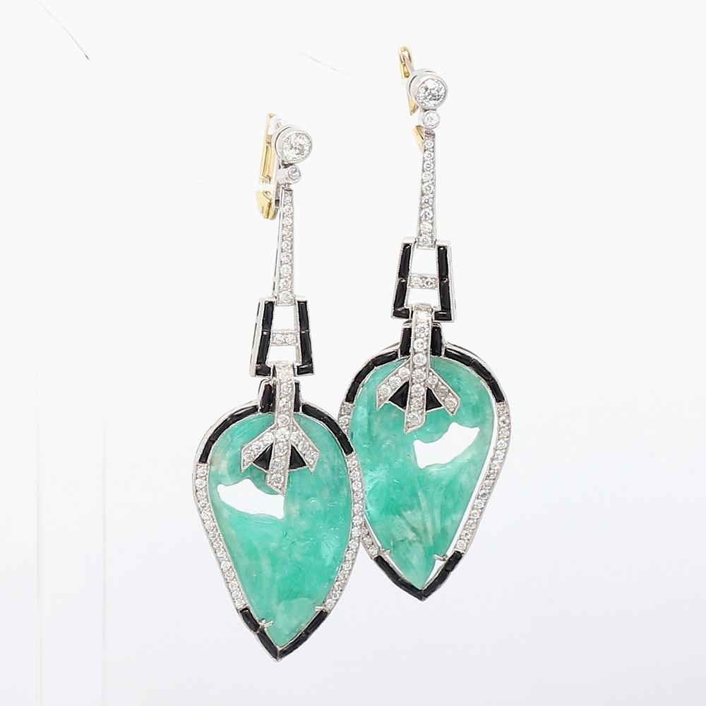 Platinum Earrings with Carved Emeralds, Round Brilliant Cut Diamonds, and Onyx Accents

These exquisite platinum earrings feature stunning carved emeralds, beautifully complemented by round brilliant cut diamonds and striking onyx accents. Weighing