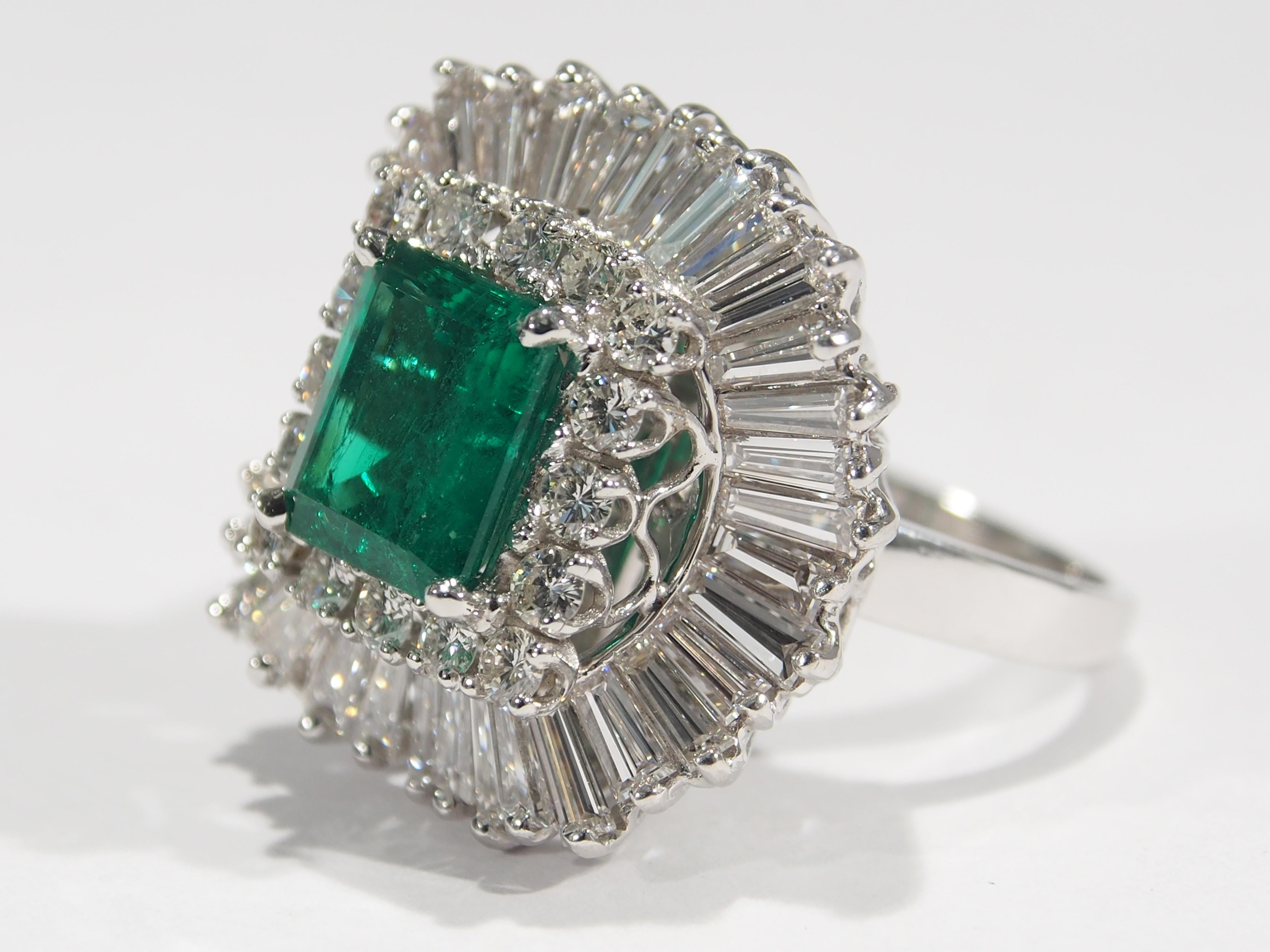 A Lovely Ballerina Ring/Pendant set with a 2.60ctw Colombian Emerald surrounded by (16) Round Brilliant Cut Diamonds and (36) Tapered Baguettes G-H in color, VS in clarity and approximately 4.30 total weight. A unique Ring set in platinum weighing