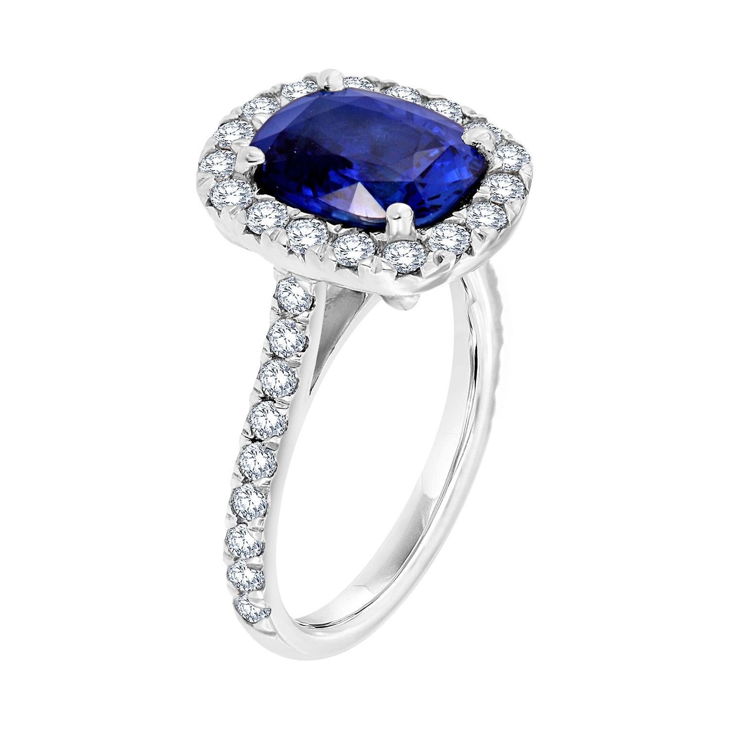 This stunning platinum ring features an Elongate Cushion 3.57 carat Blue Sapphire from Sri-Lanka GIA Certificate 6213629948. The sapphire is encircled by brilliant round diamonds that showcase its vibrant blue color. A row of perfectly matched