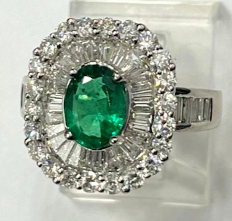 This ring features a beautiful .93Ct Fine Emerald that is rich in color and also very clear. The Ballerina style ring has 38 Natural White Baguette Diamonds of .92Ct Total Weight and 22 Natural White Round Diamonds of .77Ct Total Weight. The quality