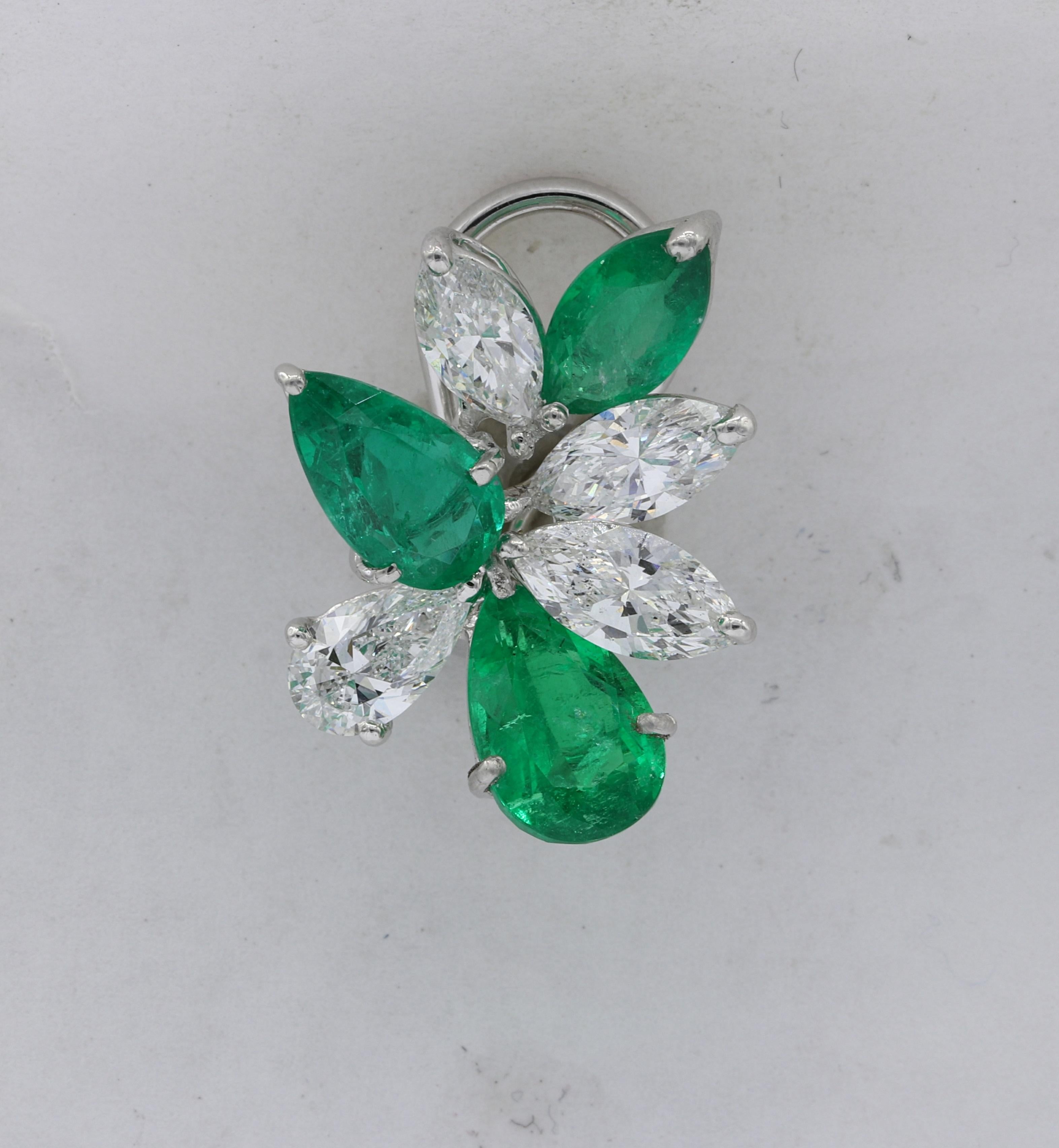 Platinum Emerald and Diamond Cluster Earrings, features 6.71 Carats of Colombian Emeralds with 4.01 Carats of diamonds. Stunning combination of color and shape