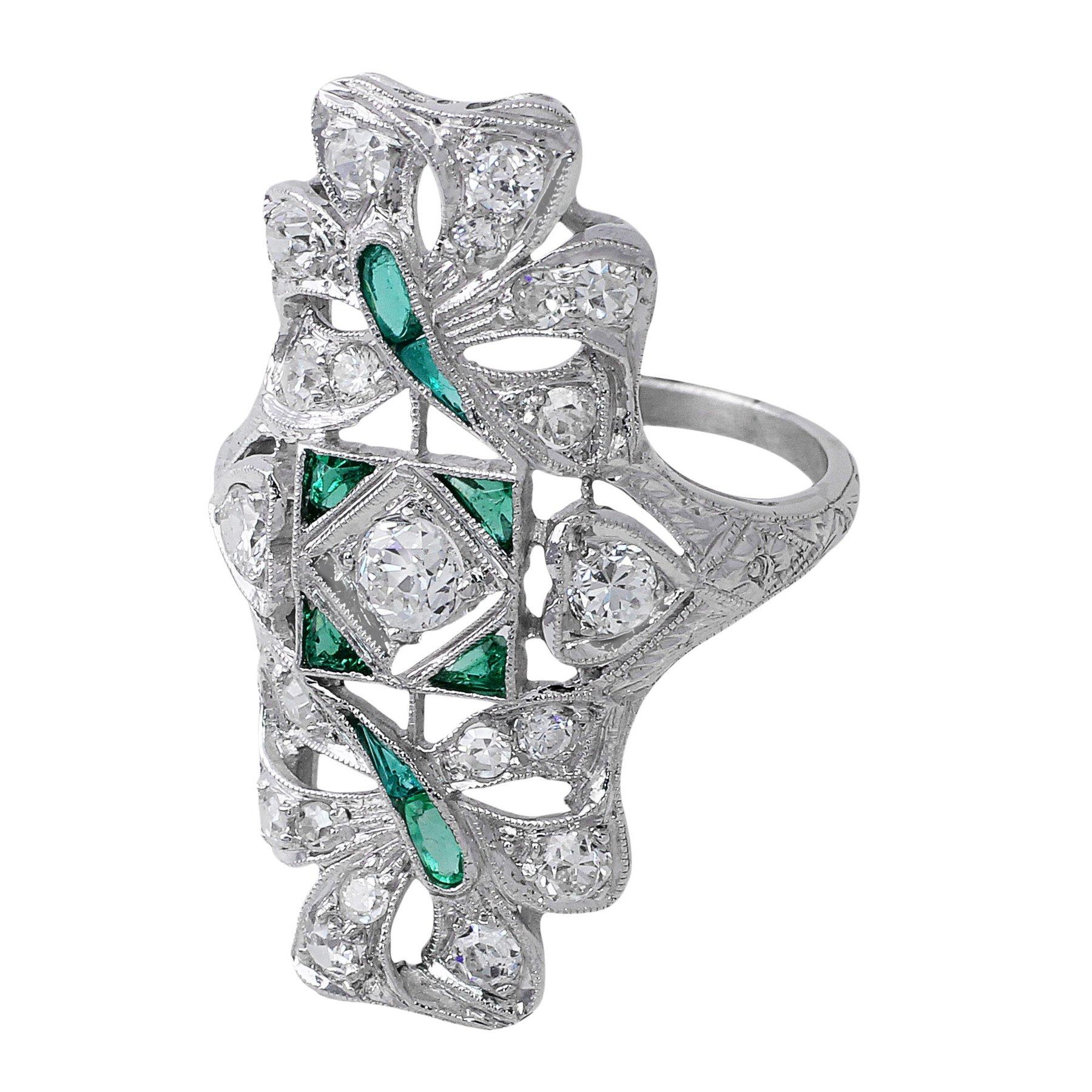 Estate Emerald and Diamond Panel Ring. Platinum ring with 21 round brilliant cut diamonds totaling approximately 1ct and 8 emeralds totaling approximately 0.25cts.