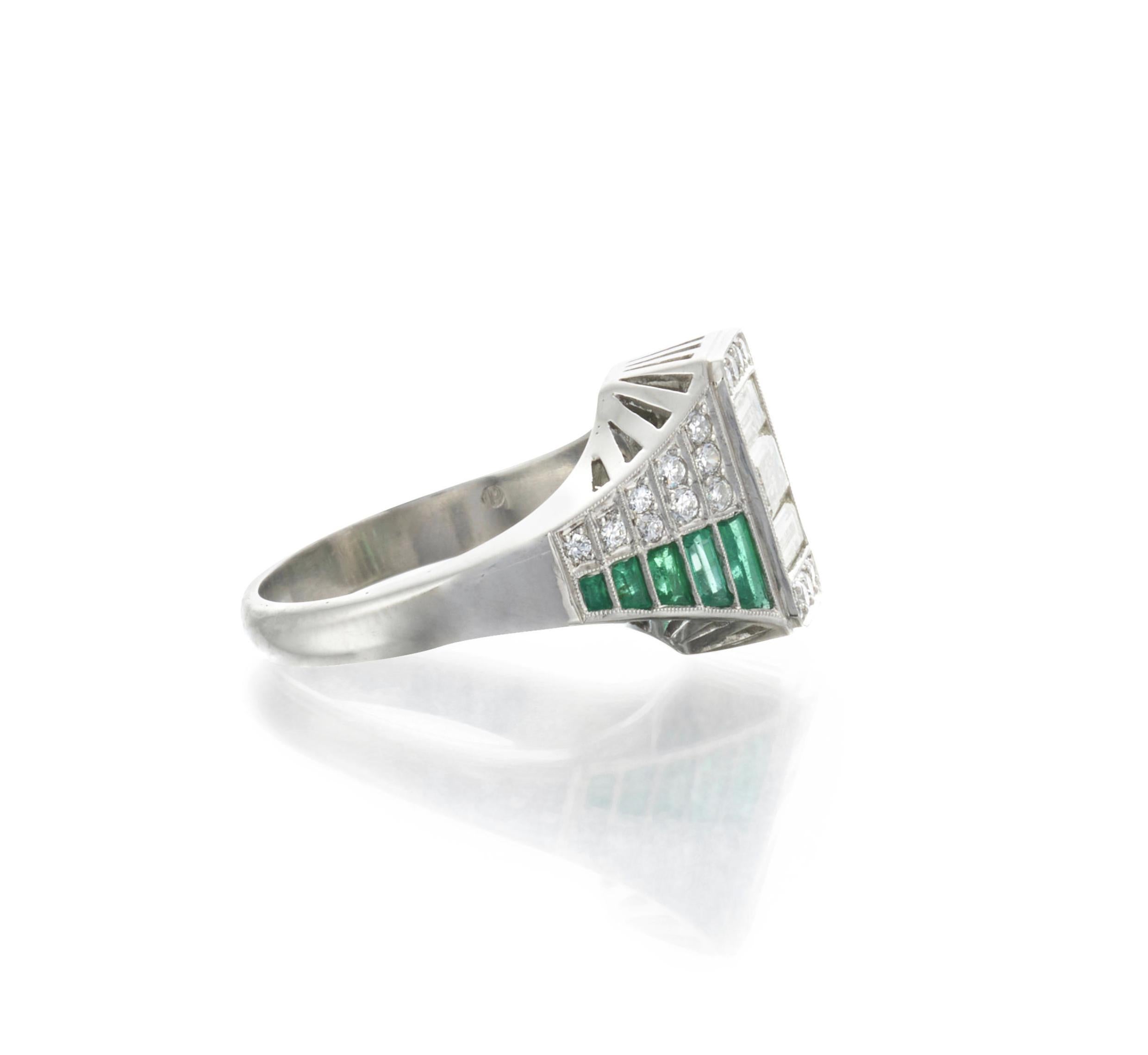 Platinum Emerald and Diamond Ring

Details:
Centering baguette and old European-cut diamonds, with tapered shoulders set with old European-cut diamonds and fancy-cut emeralds, approx. total diamond weight is 1.35 carats.
Ring size: 7 1/2'
Stamped: