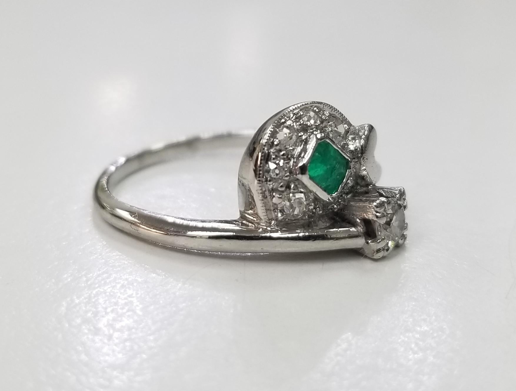 Platinum  emerald and diamond ring, containing 1 emerald weighing .25pts. and 6 round diamonds of very fine quality weighing .32pts. ring size is 6 and can be sized to fit for free.