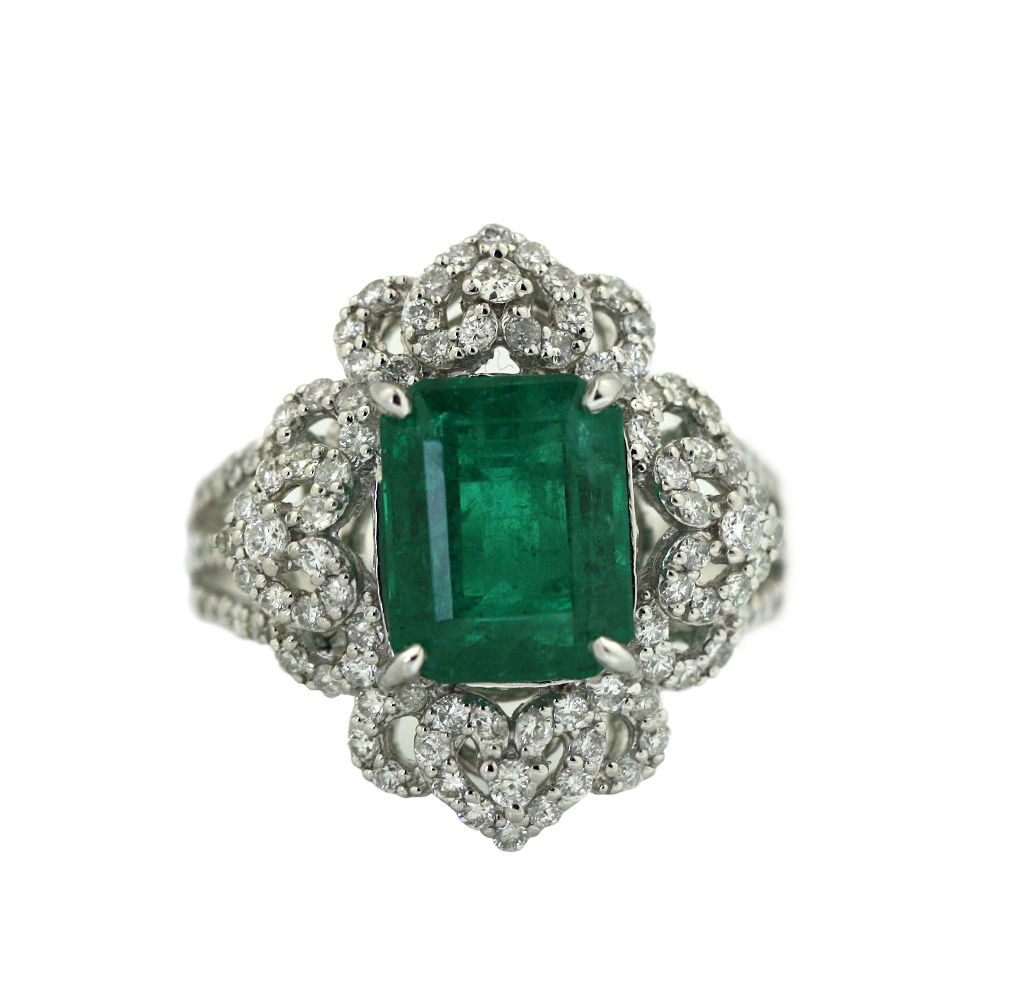 
Platinum Emerald and Diamond Ring 
Centering a rectangular/emerald-cut emerald, measuring 10.13 x 8.09 x 6.08 mm, weighing approximately 3.96 carats, framed and accented by one-hundred eight round diamonds 
weighing approximately 0.93 carats.