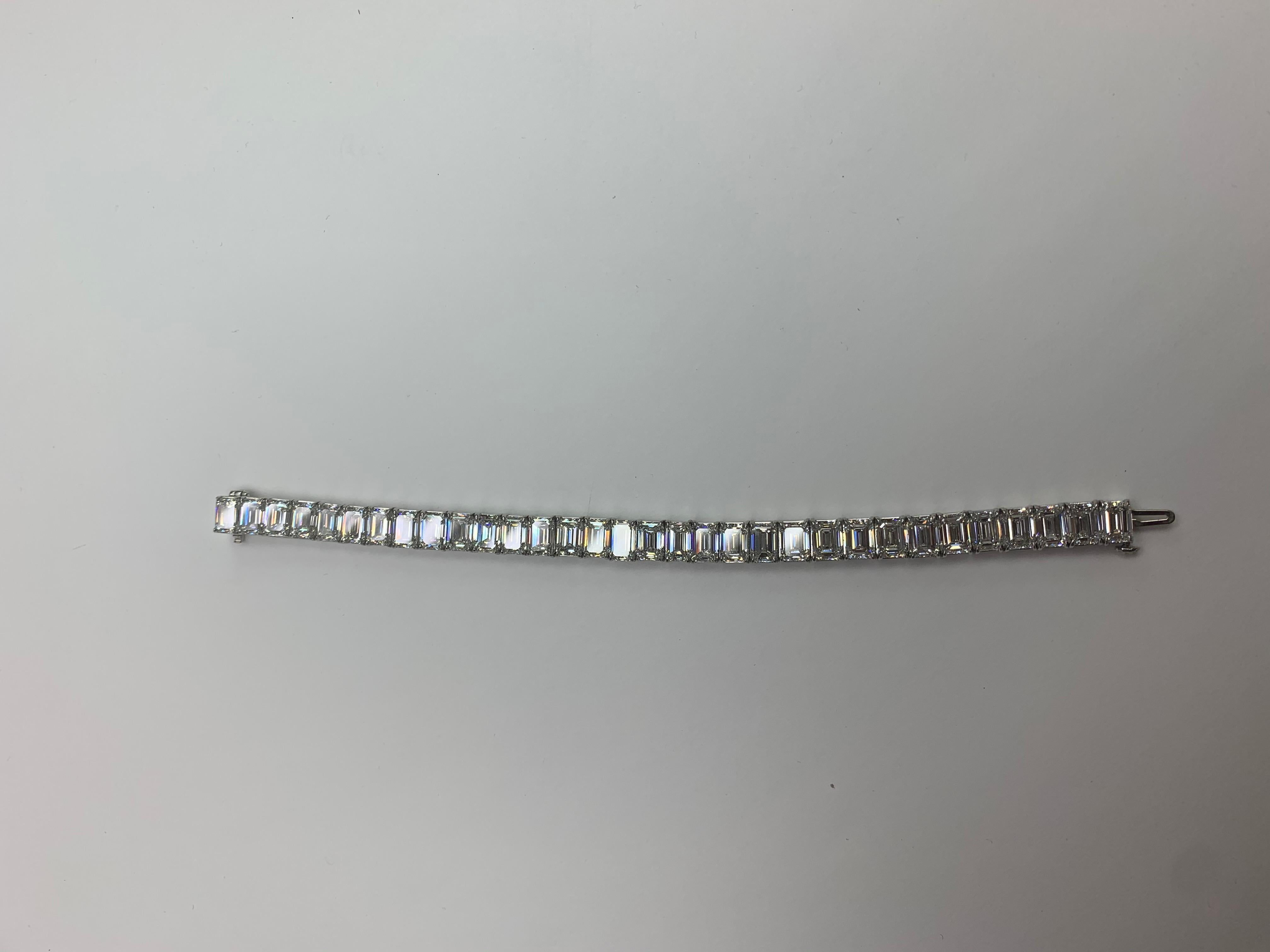 32 Emerald Cut Diamonds are set in Platinum Tennis Bracelet.
Super Classy Bracelet with all GIA certified Diamonds. The Diamonds are certified to be G and H in Color and VS2 to IF in Clarity. 
A Breakdown of the Individual Diamond and its GIA