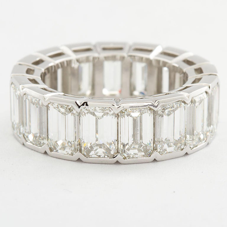 This is the eternity band that towers above all others.
A very fine diamond in platinum Emerald cut diamond eternity band set bezel style with seventeen matching emerald cut diamonds ranging H-I in color and VVS1-VS2 in clarity. Each stone is