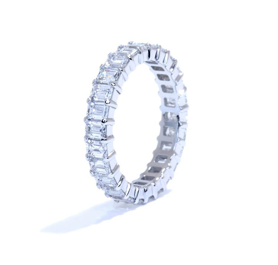 Platinum Emerald Cut Common Prong Eternity Band. This Stunning Wedding Band is Set with 23 Emerald Cut Diamonds Totaling 5.17 Carats. Kindly contact us if you wish to have a custom band made with specific number of diamonds and sizes. All diamonds