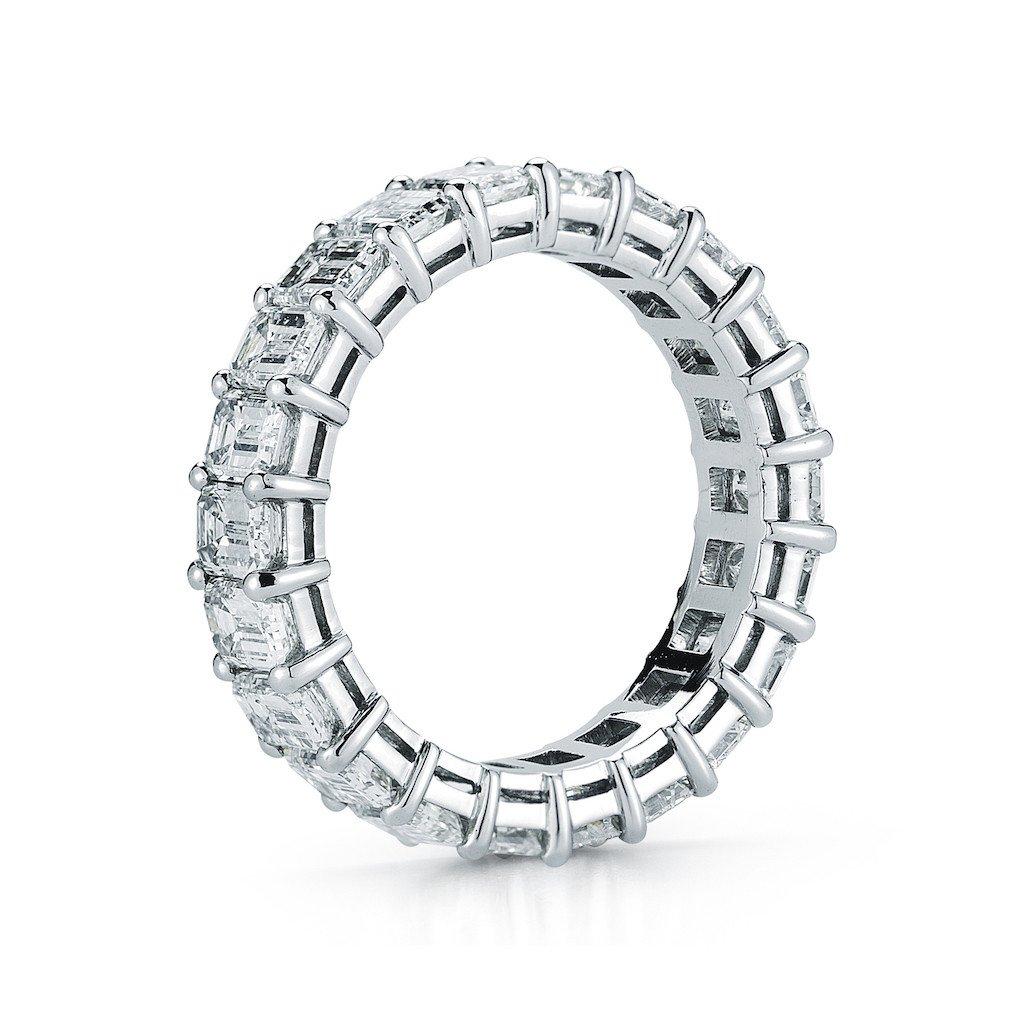 Platinum Emerald Cut Common Prong Eternity Band. This Stunning Wedding Band is Set with 18 Emerald Cut Diamonds Totaling 7.00 Carats. Kindly contact us if you wish to have a custom band made with specific number of diamonds and sizes. All diamonds