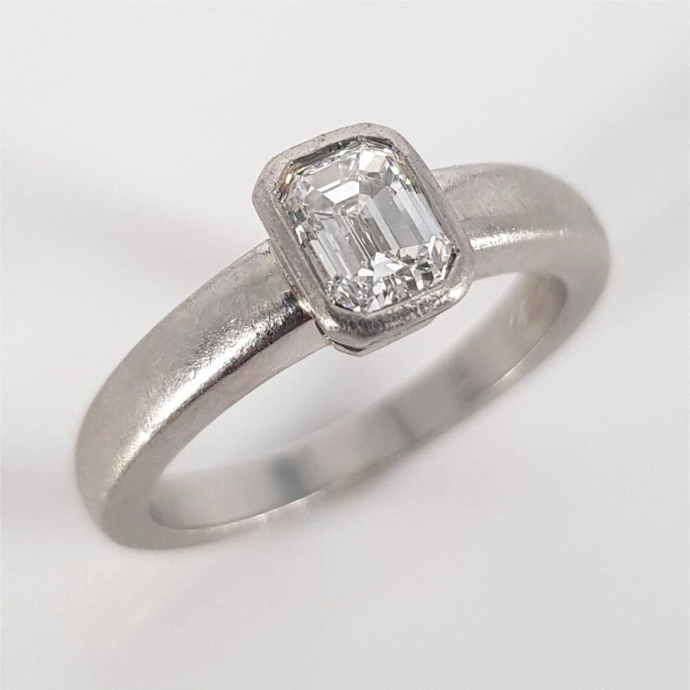 Modern Platinum Emerald Cut Diamond Ring For Sale