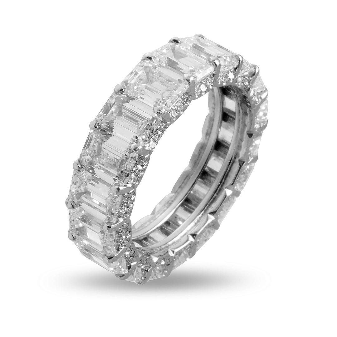 This 9.00 carat Emerald cut eternity band displays perfectly matched stones that flow synchronously to create a uniform appearance on the finger. Since the emerald cut diamonds have a larger surface area the eternity band is wider and give you more