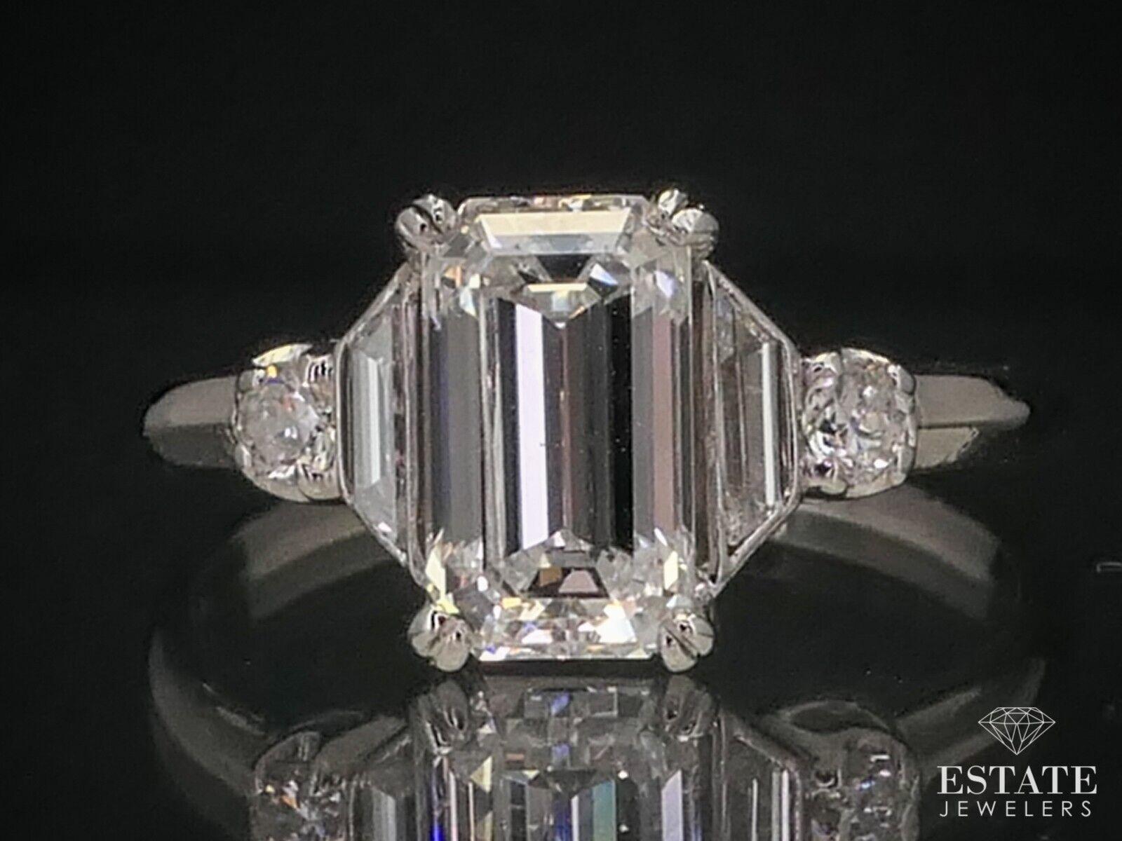 Beautiful platinum engagement ring with an approximately 1.39ctw of diamonds. That's including the approximate 1.21ct main emerald cut diamond. VS1 clarity with GH color to it. stamped PLAT SIZE-5.5 
 