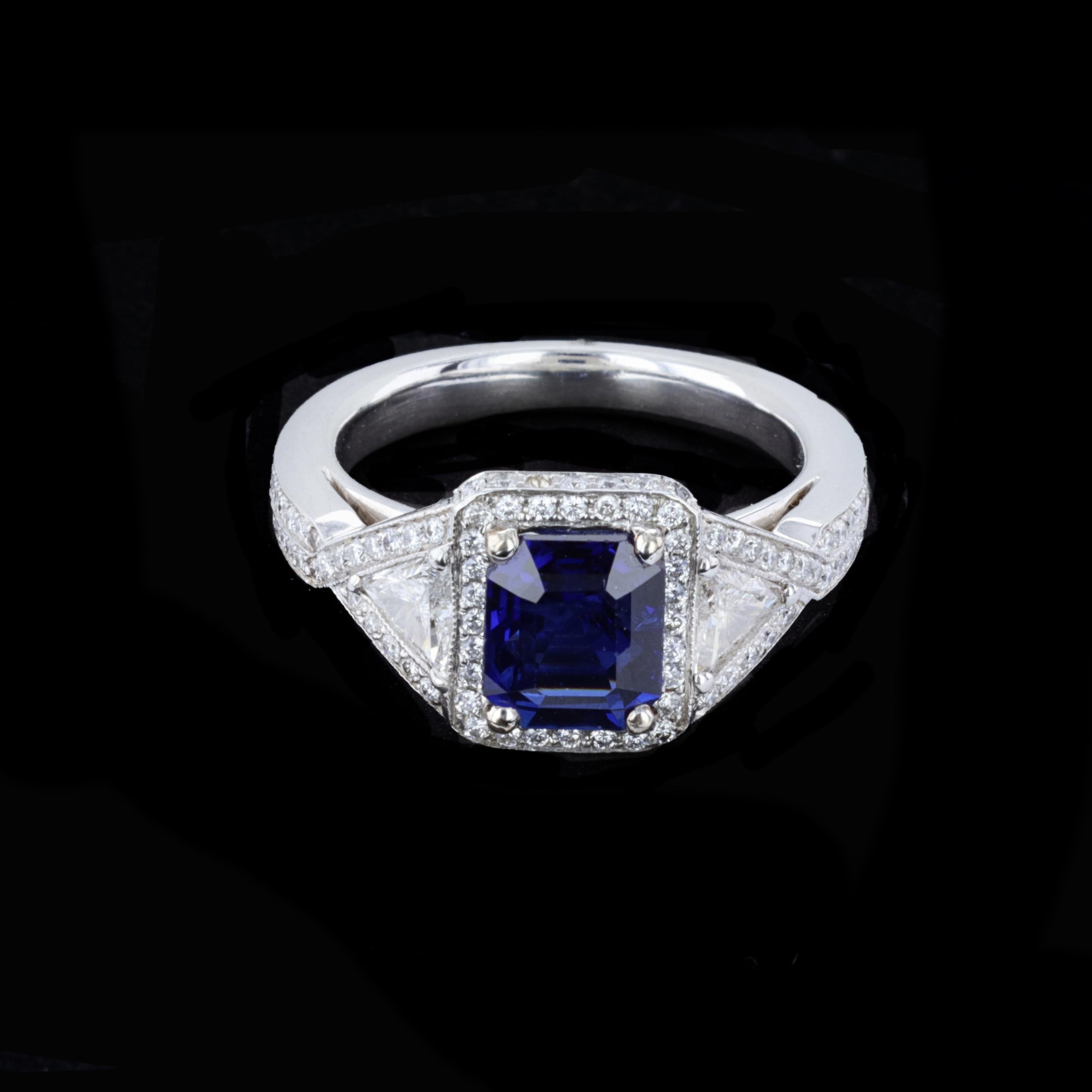 The unique design on this band is a timeless showstopper!

The emerald cut sapphire is 1.98cts.
There are two trillion cut diamonds HVS with a total weight of .6 carats
All surrounded by 146 round diamonds.
This ring is a size 6 and it can be