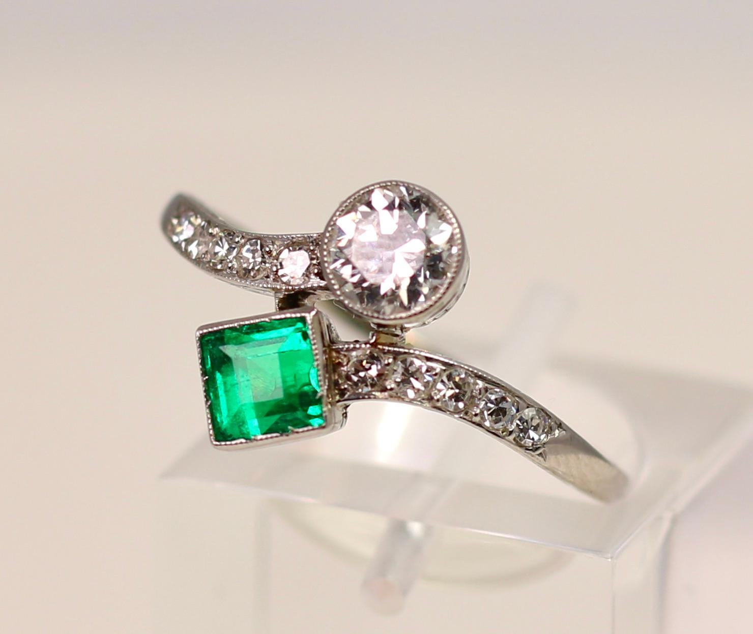 Platinum and emerald diamond bypass ring.  Size 8 and can be sized.  Princess Cut Emerald and round diamond. Stamped P 7 and 950.  