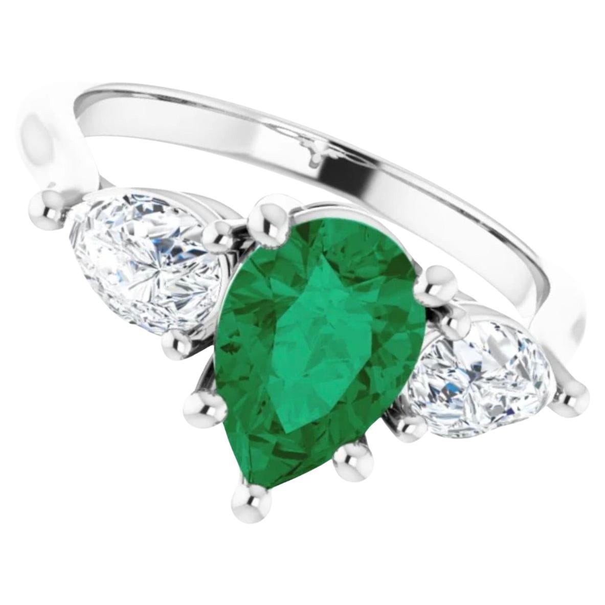 Platinum Emerald & Diamond Engagement Ring 3 Stone Pear Shape 
Primary Stones: Natural Colombian Emerald
Shape or Cut: Pear Cut
Average Color/Clarity: Medium Fine Green Color/Clarity VS
Total Emerald Weight: 1.50 Carats  (9.00x6.10mm)
Flanking the
