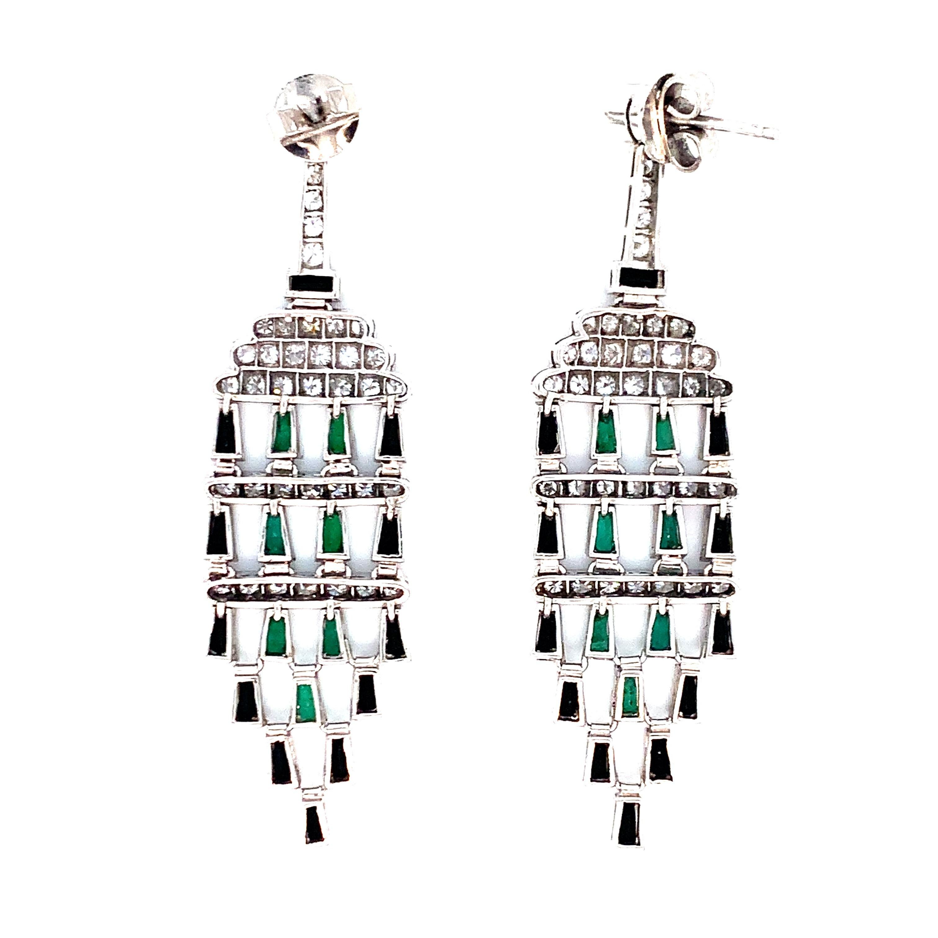 An art deco recreation, these platinum earrings contain 2 diamonds that weigh 0.44 carat, 72 old mine cut diamonds that weigh 1.87 carat, emeralds that weigh 3.71 carats, and onyxes. Total weight is 17.8 grams. 