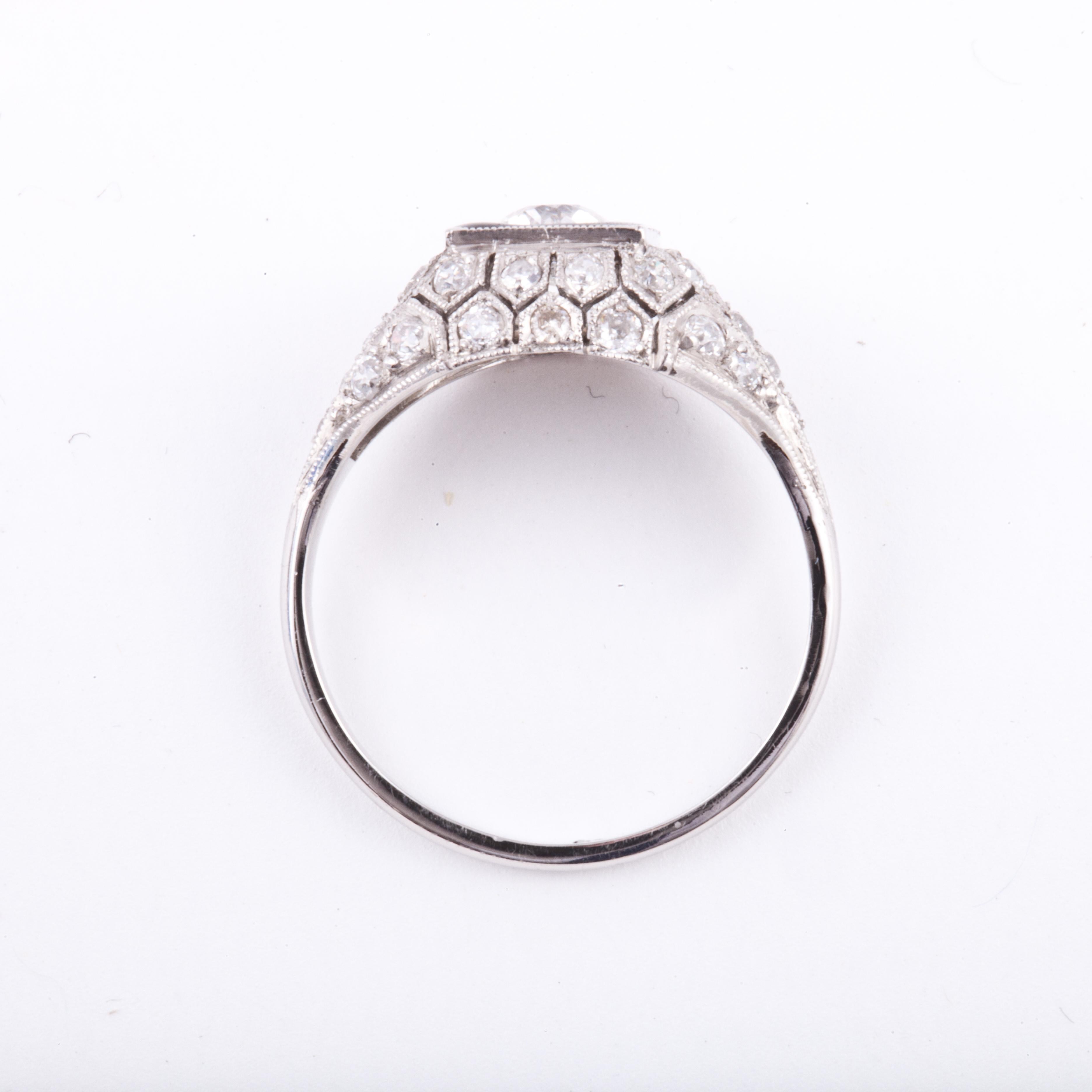 Platinum diamond ring featuring an Old European cut diamond ring framed by black enamel.  Center diamond weighs 0.42 carats; J color and SI1 clarity.  There are also 32 round diamonds with a total carat weight of 0.65 carats; H color and VS clarity.