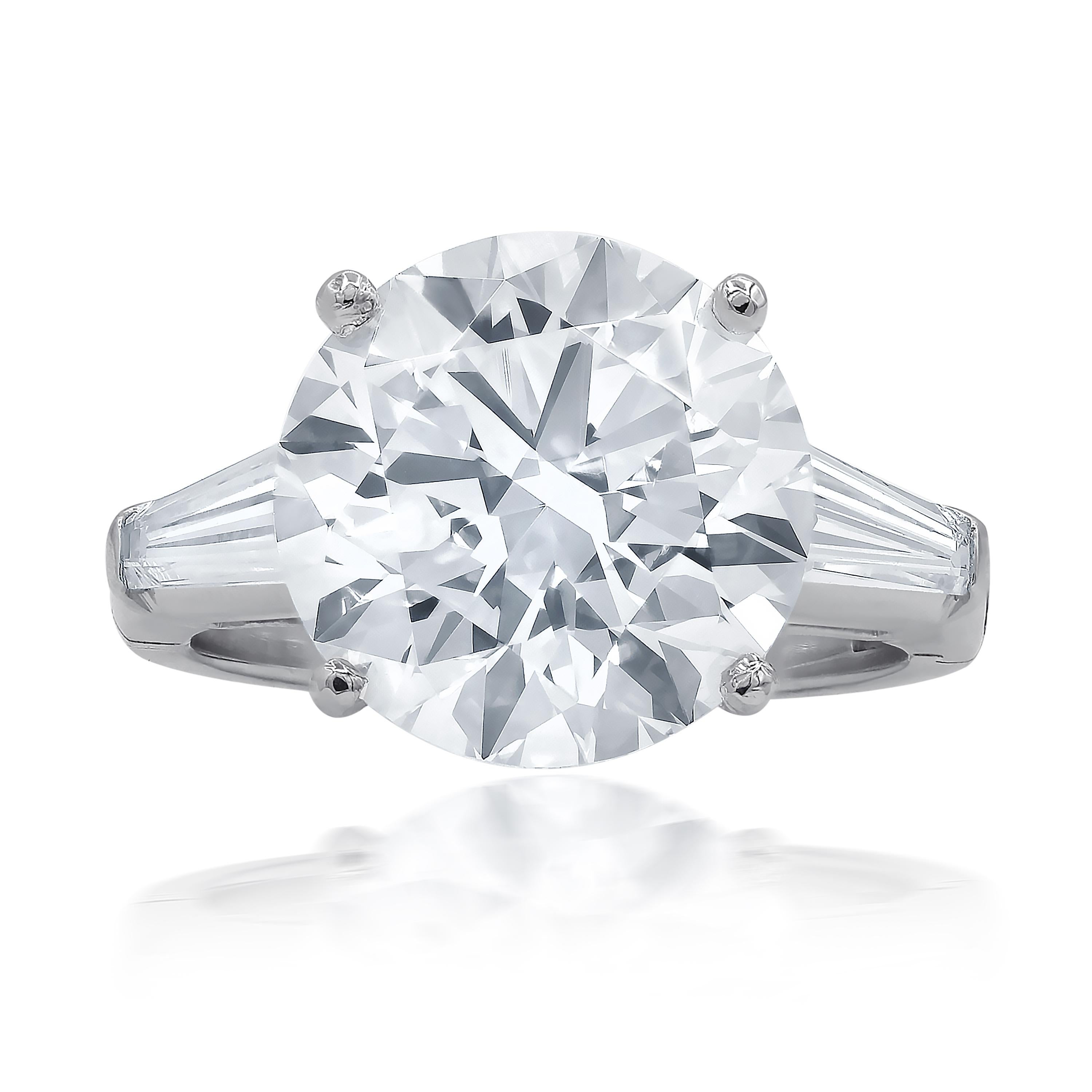 Platinum engagement ring features 7.01 carat of round diamond I-vs2 (rdc3278) and 1.00 ct baguette on the sides.
