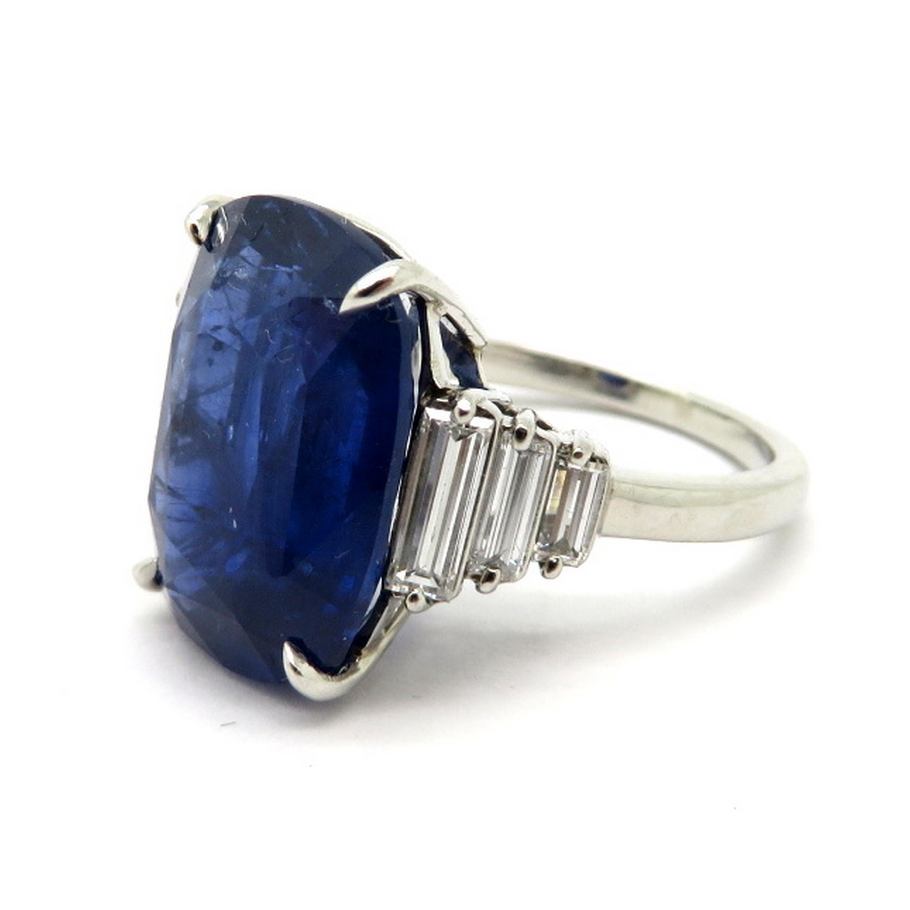 Platinum estate 12.92 carat cushion sapphire and baguette diamond fashion ring. Showcasing one fine quality cushion cut blue Sapphire weighing approximately 12.92 carats. Accented with six baguette shaped diamonds with various measurements weighing