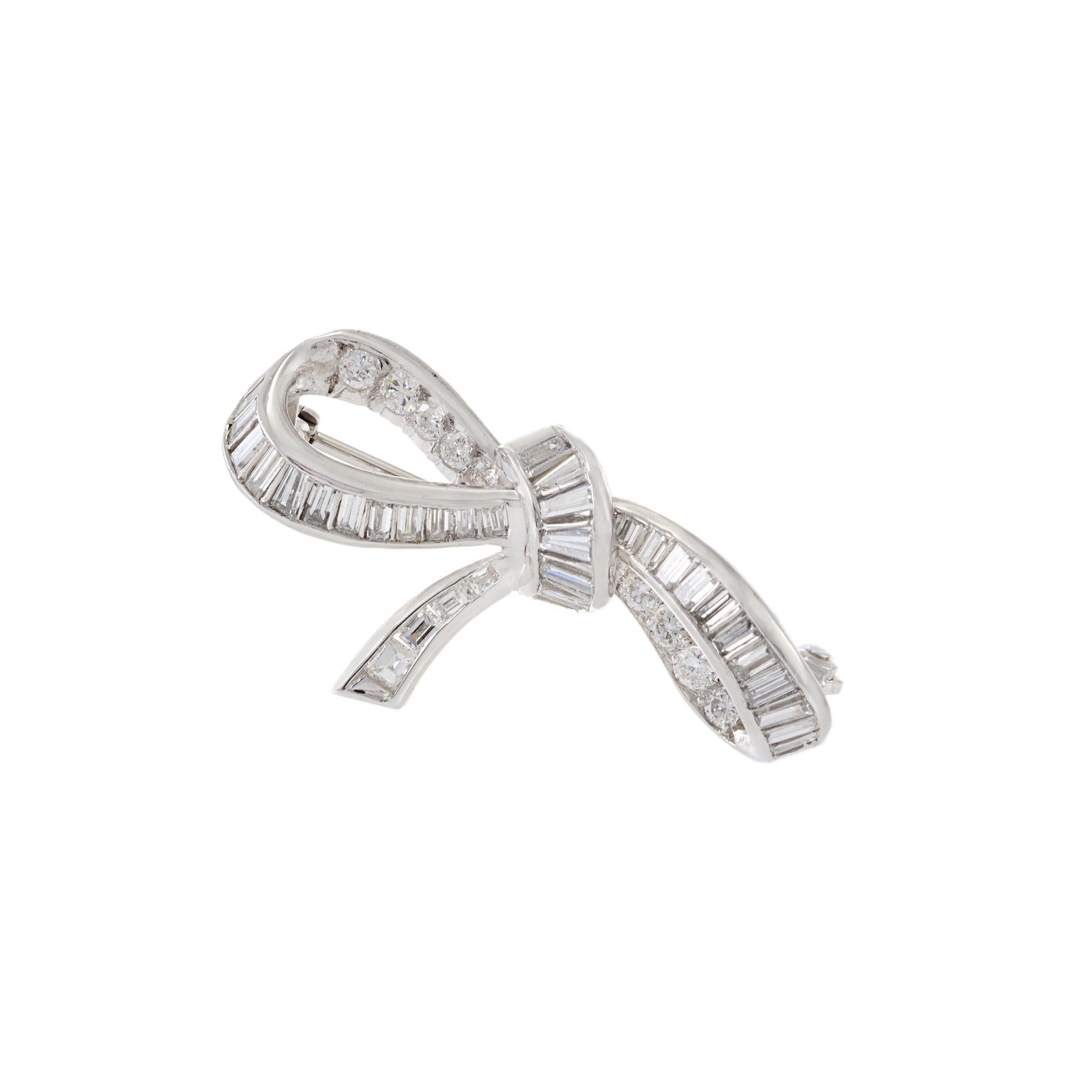 Expertly crafted with an elegant Art Deco design, this Platinum Estate Diamond Bow Brooch boasts a staggering 2.00 carats of round cut diamonds graded F in color and VS in clarity. Experience the timeless luxury and brilliance of fine diamonds with
