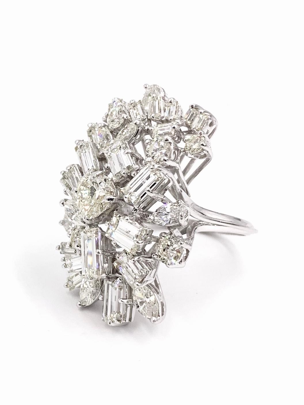 A dramatic showstopping vintage platinum diamond spray ring composed of approximately 8.75 carats of fancy cut and round brilliant white diamonds. Center of ring features a heart shape diamond weighing approximately .75 carats at approximately H