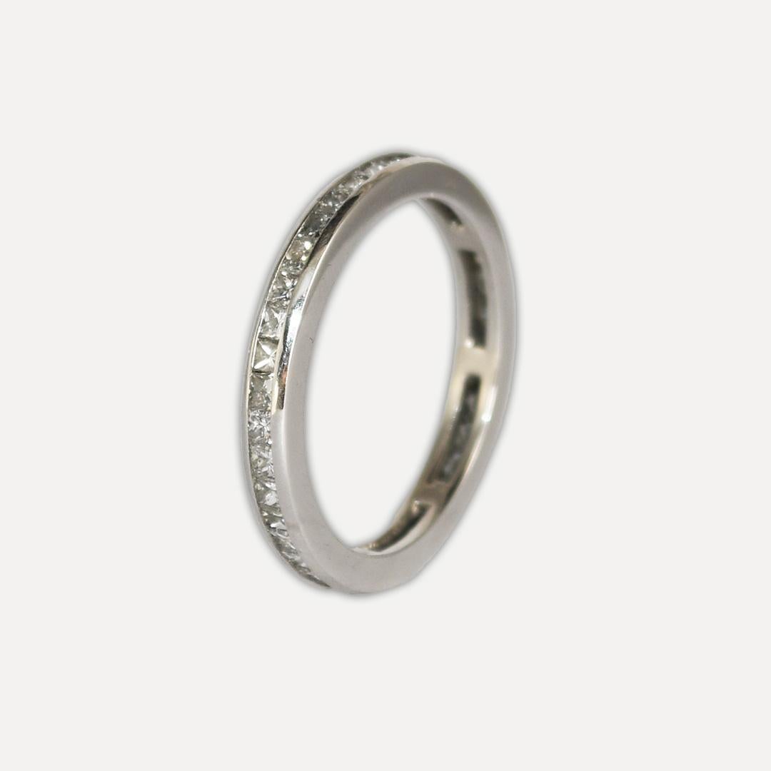 Platinum and diamond eternity band.
Tests platinum and weighs 3.1 grams.
The diamonds are princess cuts, 1.00 total carats, i to j color, vs to si clarity.
The band measures 2.5mm thick.
The ring size is 5 3/4.
Excellent condition. 