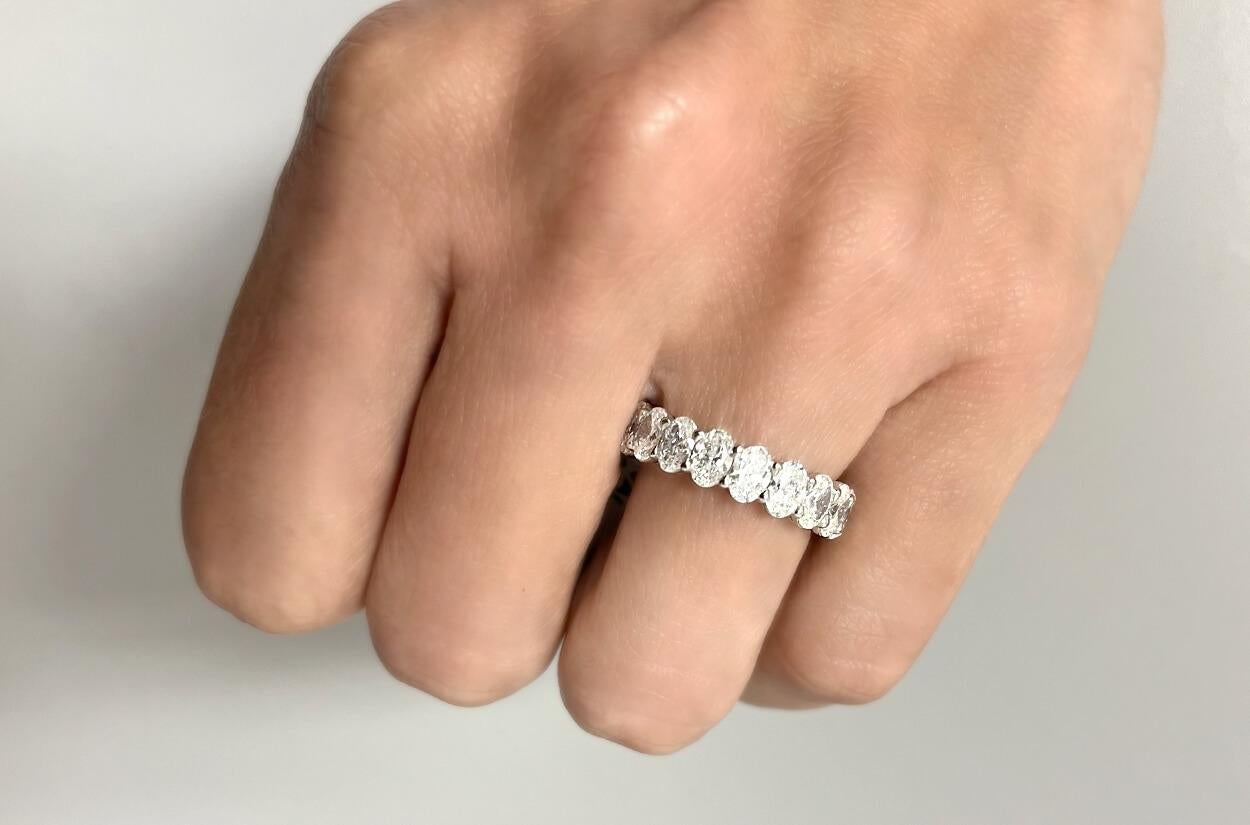 This Eternity Platinum Ring features a stunning array of natural oval diamonds. Set in continuous loop around the band, these diamonds symbolize eternity and everlasting love. The platinum setting ensures durability and enhances the brilliance of