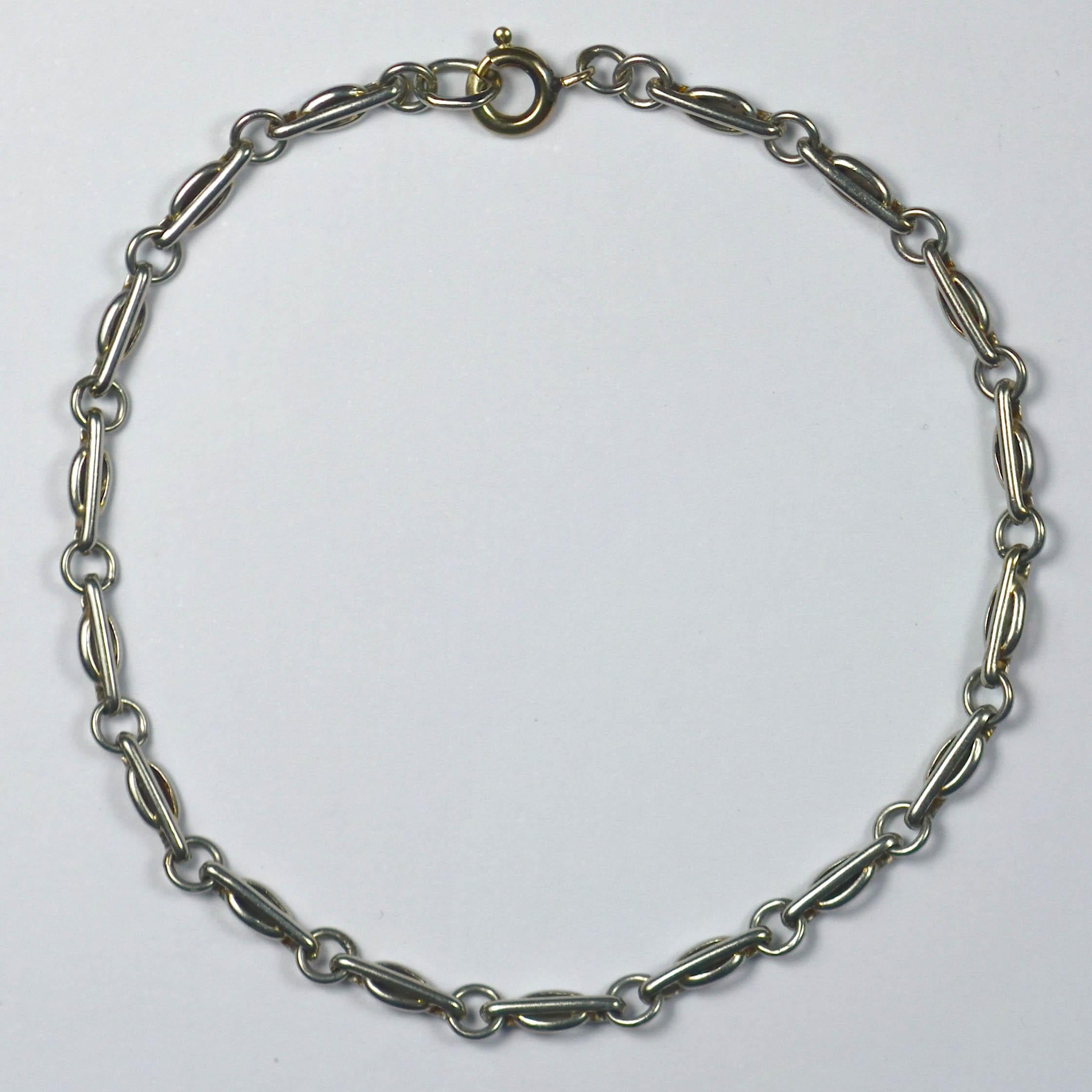 A platinum fancy link bracelet which would look elegant on its own, or would house a charm collection.

There is a very rubbed mark for platinum on the 5th link from the clasp, of which the letters 'AT' remain visible. The clasp is 18 karat yellow