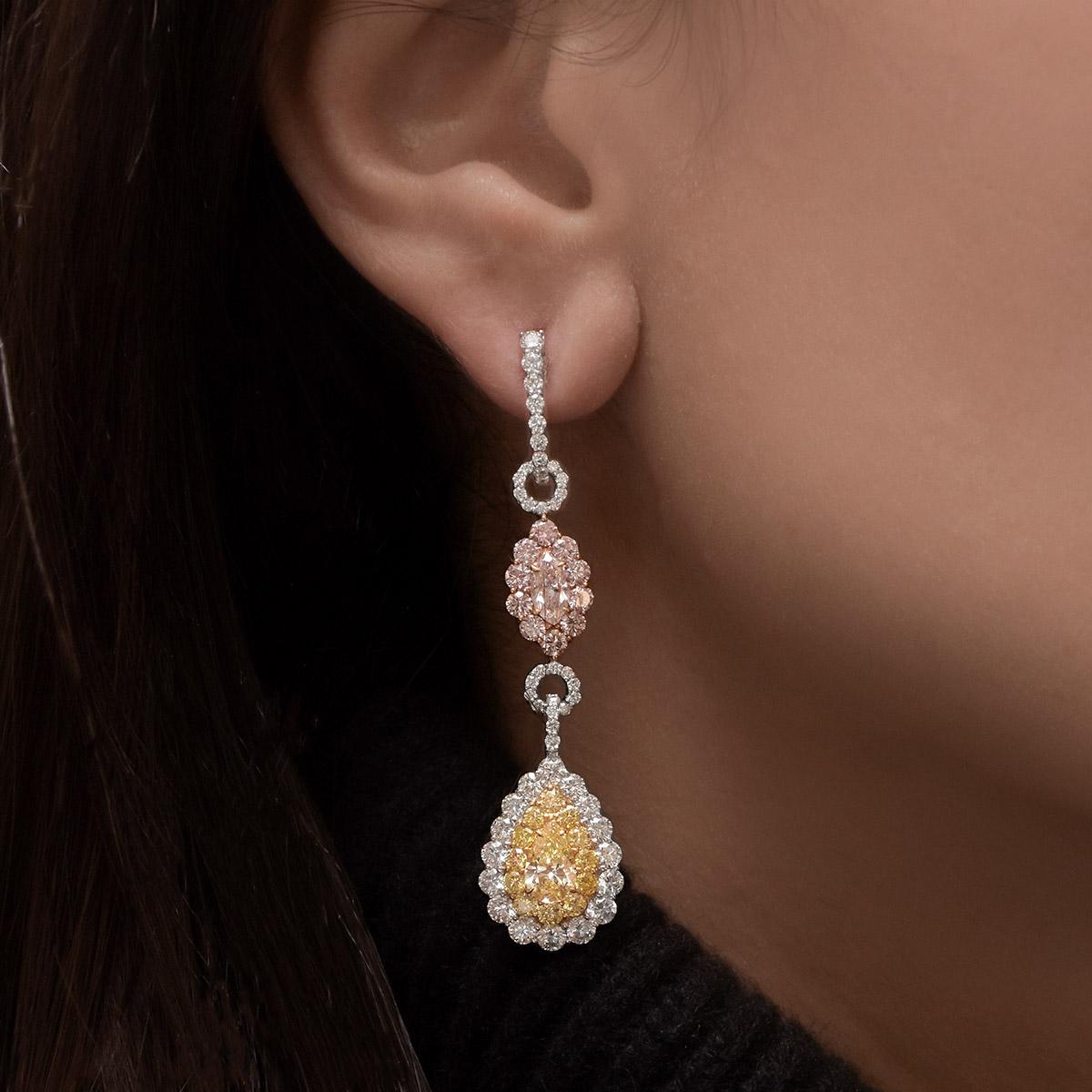 These spectacular hanging earrings are set with natural fancy yellow diamonds, natural fancy pink diamonds along with white diamond accents. Set in platinum and 18-karat yellow and rose gold.
The Pear shaped yellow diamonds total .56cts, and .61cts.