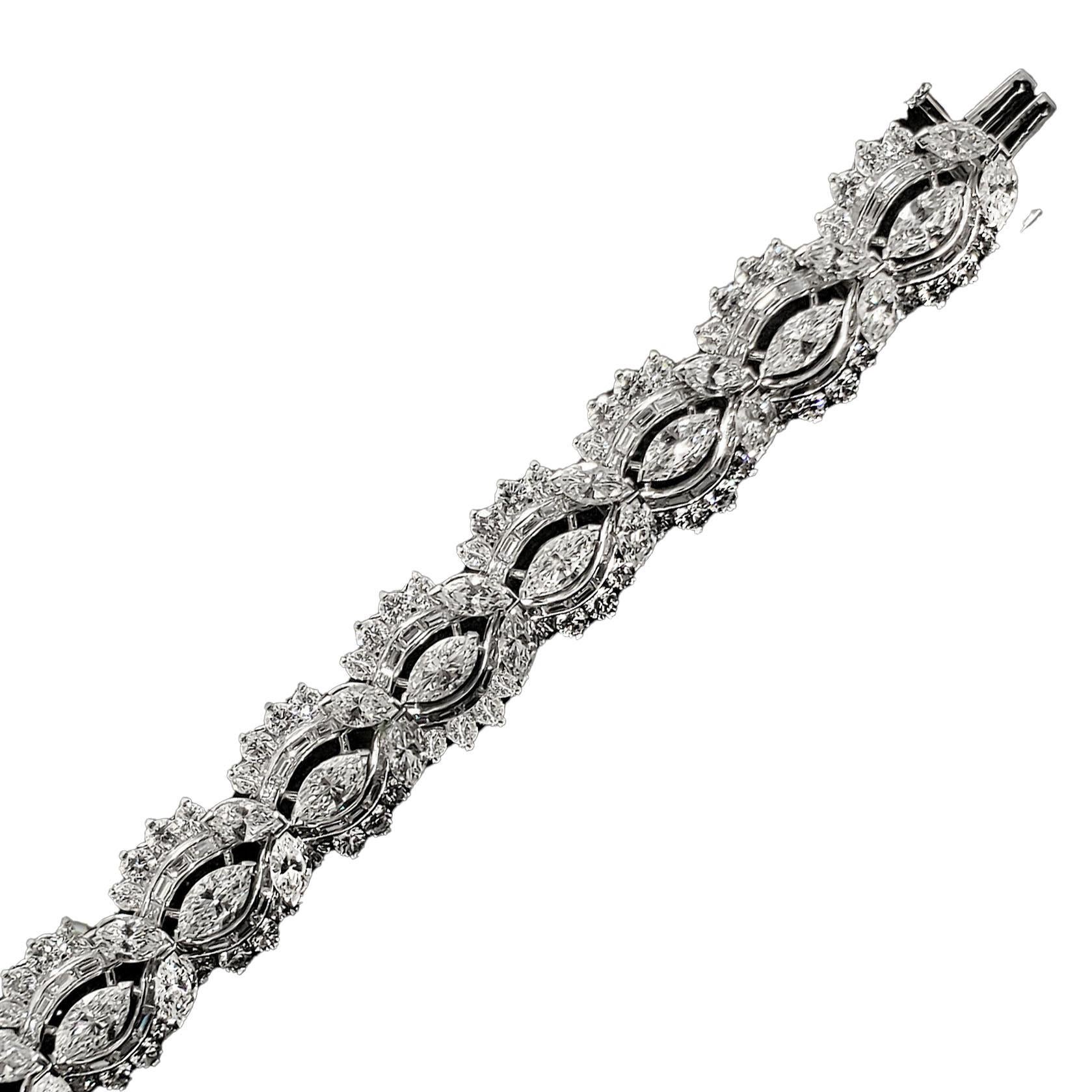 Stunning estate platinum fancy shape diamond tennis bracelet. The bracelet has 273 white diamonds weighing an estimated 22 carats total weight. There are 39 marquise, 130 baguette and 104 round brilliant shape diamonds. The bracelet is in excellent