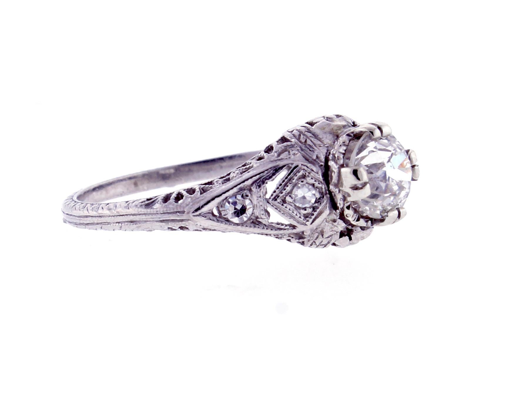 A stunning platinum filigree ring featuring a 0.81-carat Old European Cut diamond, graded I-SI1, accented by four single cut diamonds totaling 0.04 carats. Circa 1920, this piece showcases exquisite craftsmanship and timeless elegance.