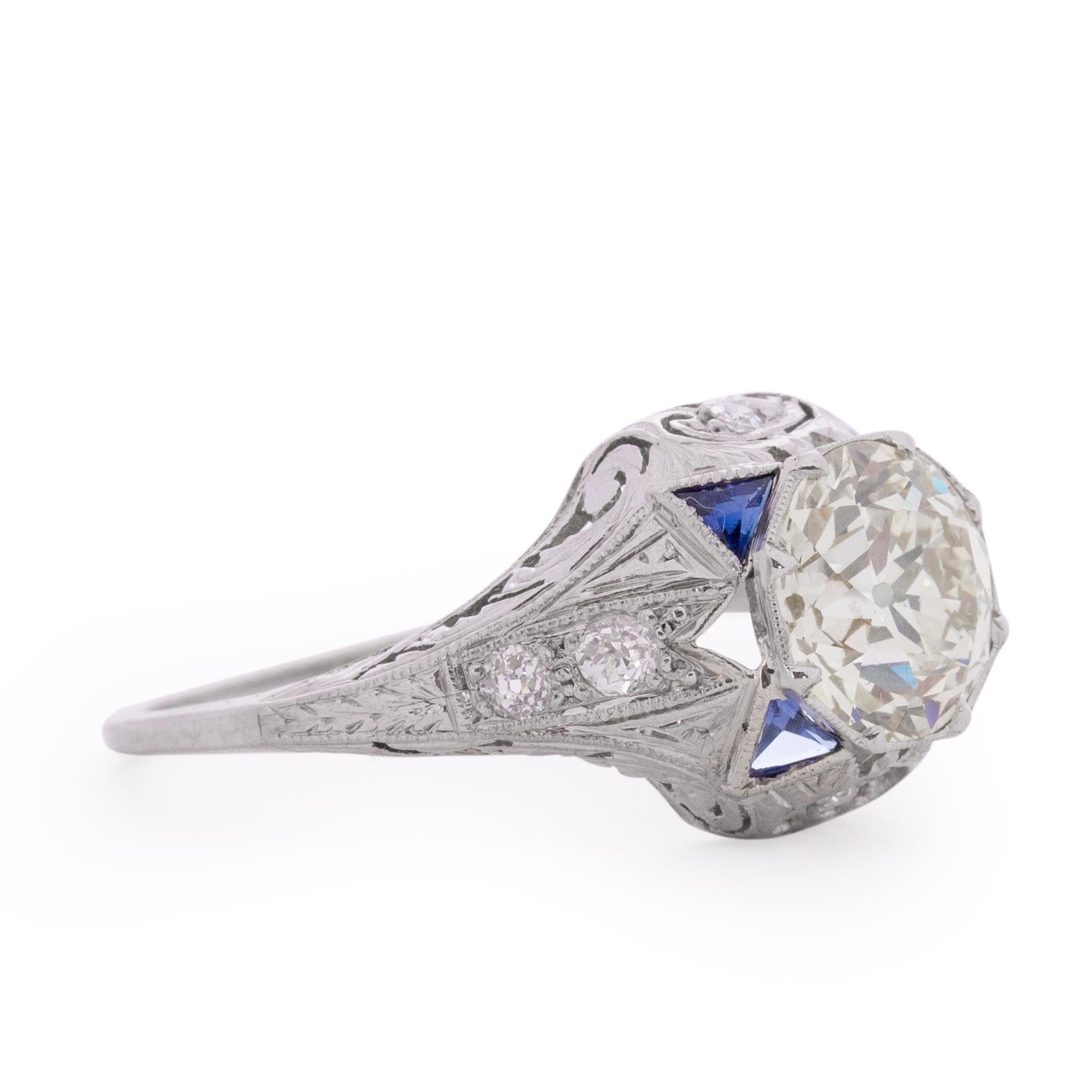 This Art Deco beauty is an excellent example of the era. There is a pierced open back pattern throughout the ring to allow light and brilliance to be at a maximum for each stone. The center diamond is 2.08 carat and SI1 clarity. The sapphire accents