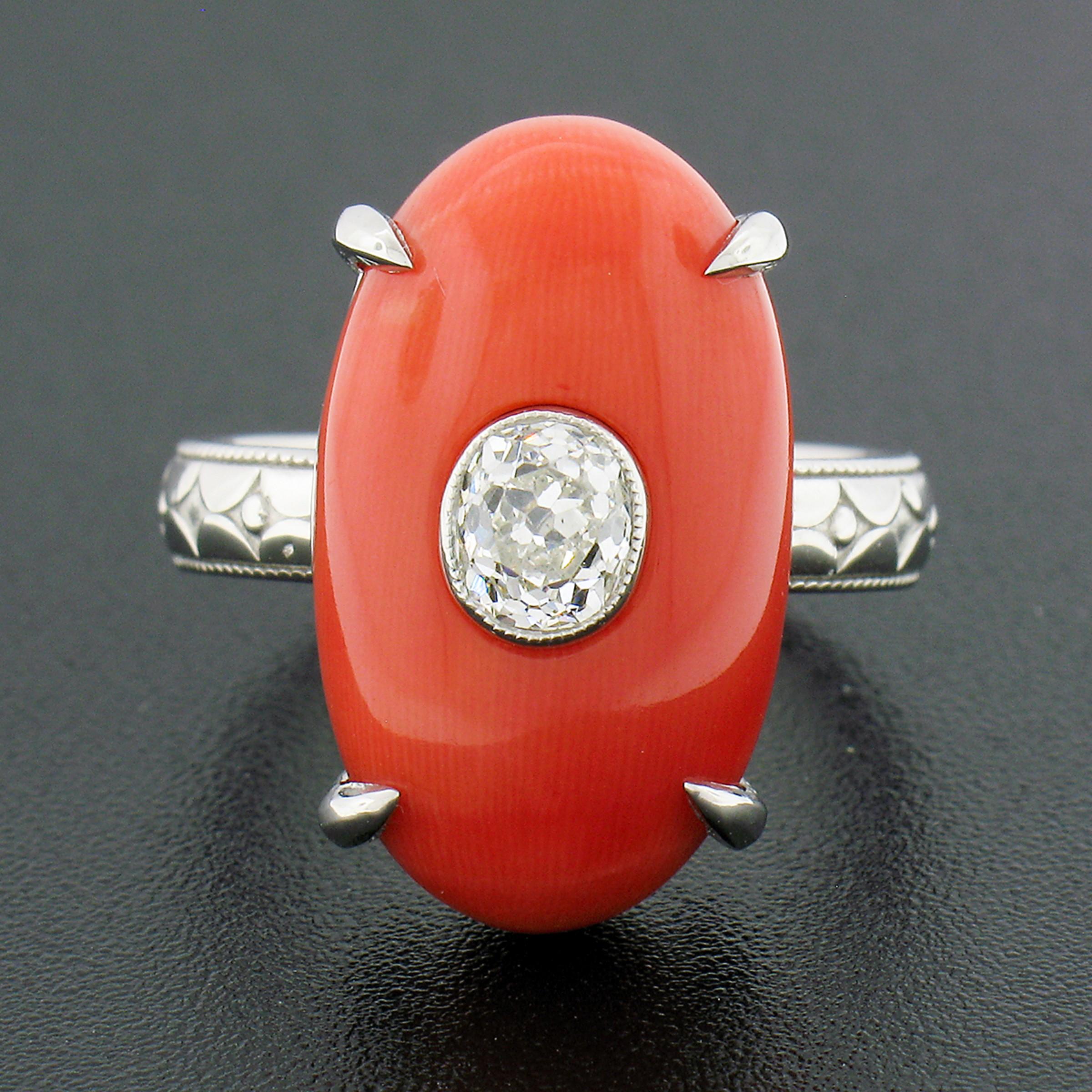This truly unique statement ring was newly crafted from solid 950 platinum. The ring features an oval cabochon cut piece of natural coral claw prong set at its center. The coral is GIA certified, measures exactly 20.33x11.88mm, and displays a very