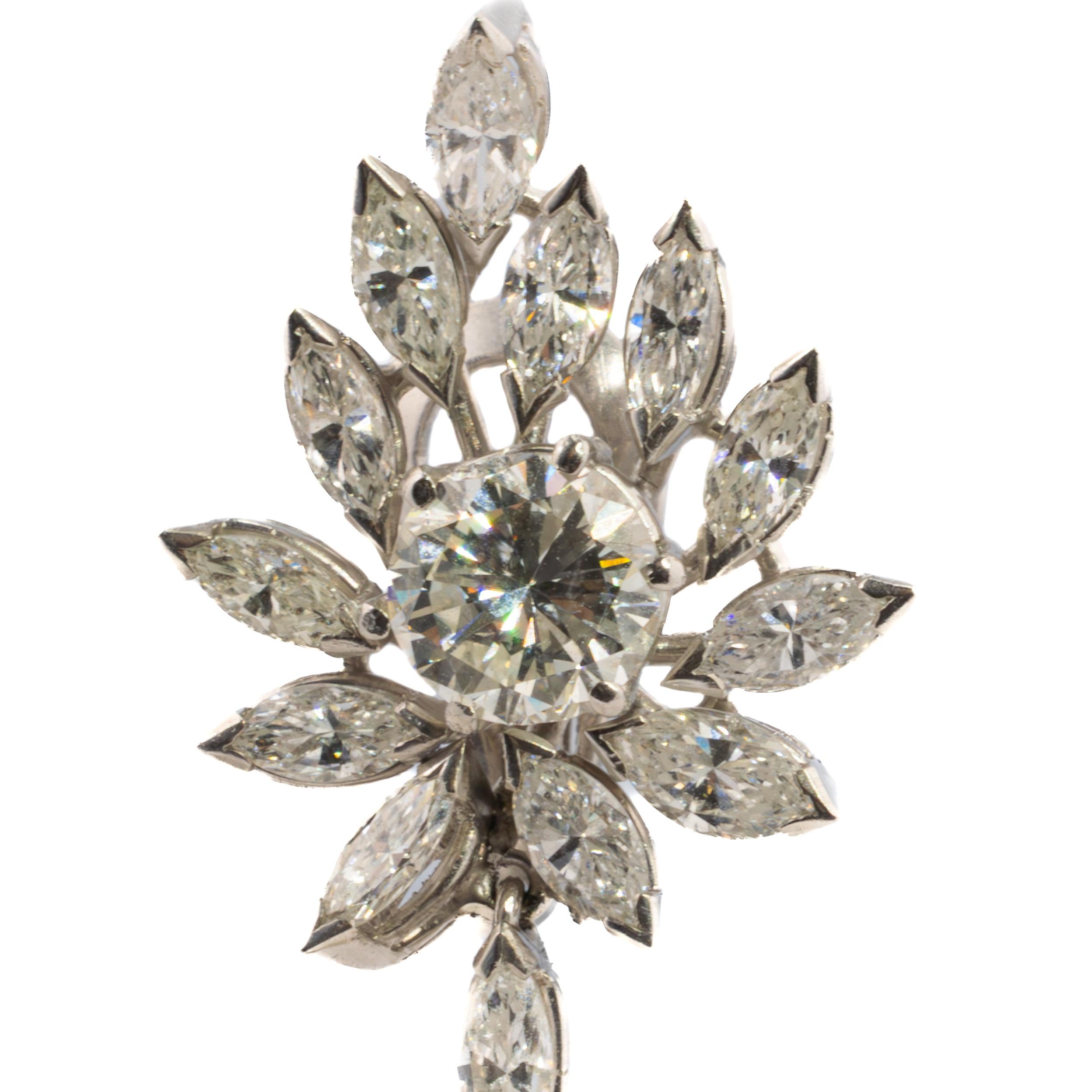 Platinum Floral Diamond and Pearl Drop Earrings

These platinum earrings are designed as elegant floral sprays composed of brilliant and marquise-cut diamonds, centered by two sparkling round diamonds. Each floral cluster suspends a luminous white