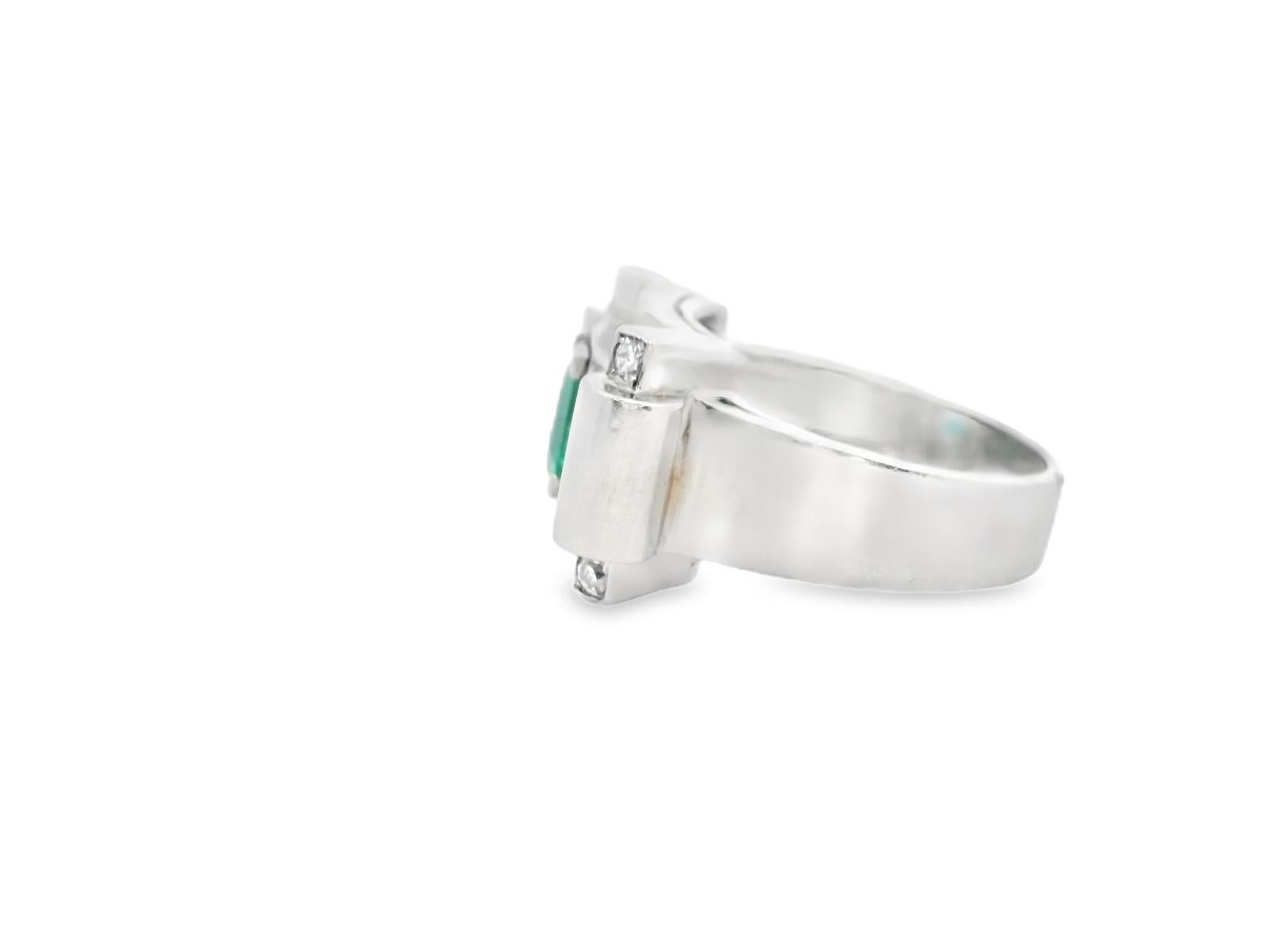 This striking ring showcases a bold design, centered around a captivating emerald-cut emerald. The emerald's vibrant green hue is accentuated by its 0.76-carat weight, creating a mesmerizing focal point.

Set in luxurious platinum, the ring's
