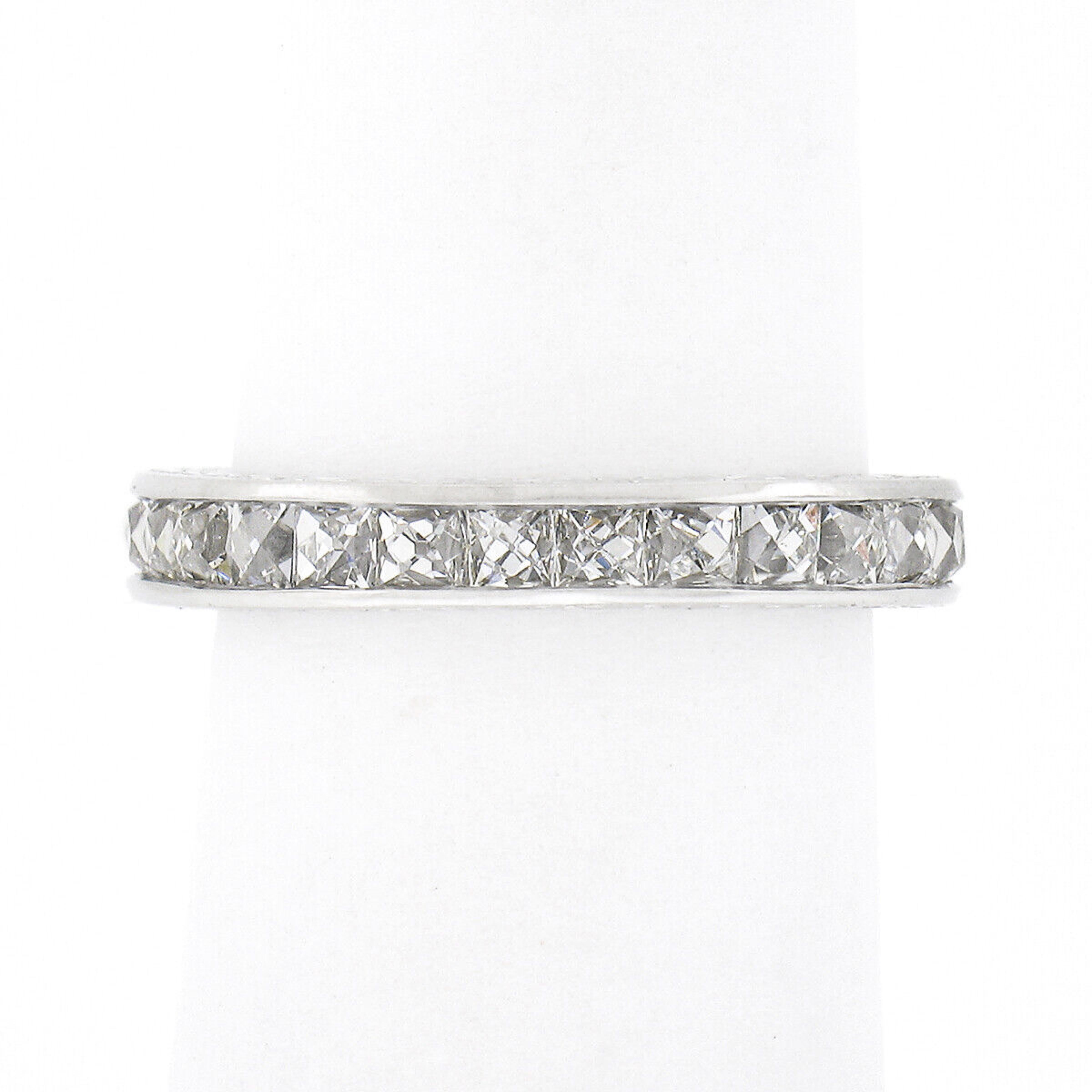 This gorgeous vintage diamond eternity band ring was crafted from solid platinum and features 27, top quality, square French cut diamonds neatly channel set entirely throughout the band. These stunning and super lively diamonds total approximately 3