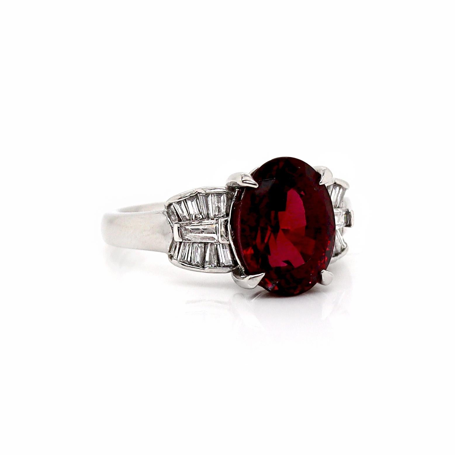 Platinum Garnet And Diamond Dress Ring

This elegant dress ring features a captivating oval cut Garnet in a striking purplish red hue. Meticulously flanked by 18 baguette cut diamonds, adding a luxurious sparkle with its brilliance. The overall