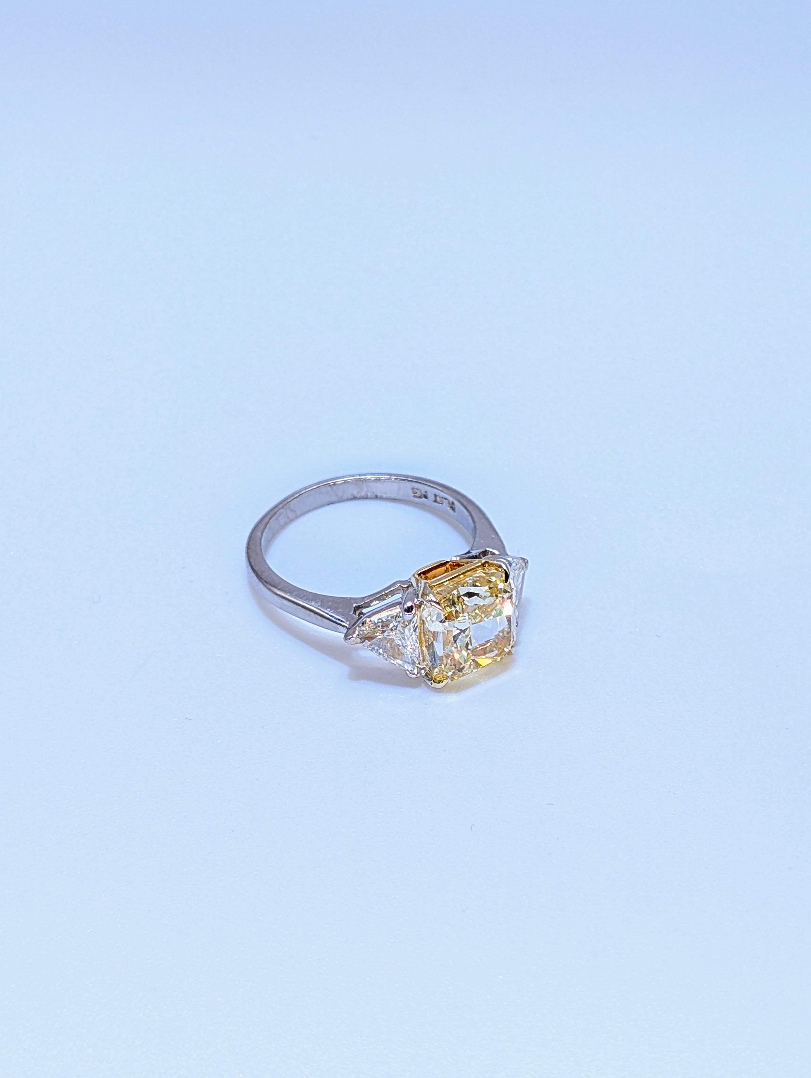 Faites une déclaration audacieuse et intemporelle avec cette exquise bague de fiançailles en platine, mettant en valeur un diamant jaune fantaisie taille coussin de 3,53 carats certifié par le GIA. D'une pureté exceptionnelle VS2, la pierre centrale